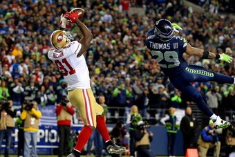 SEATTLE, WA - JANUARY 19:  Wide receiver Anquan Boldin #81 of the San Francisco 49ers makes a 26-yard touchdown catch against free safety Earl Thomas #29 of the Seattle Seahawks in the third quarter during the 2014 NFC Championship at CenturyLink Field on