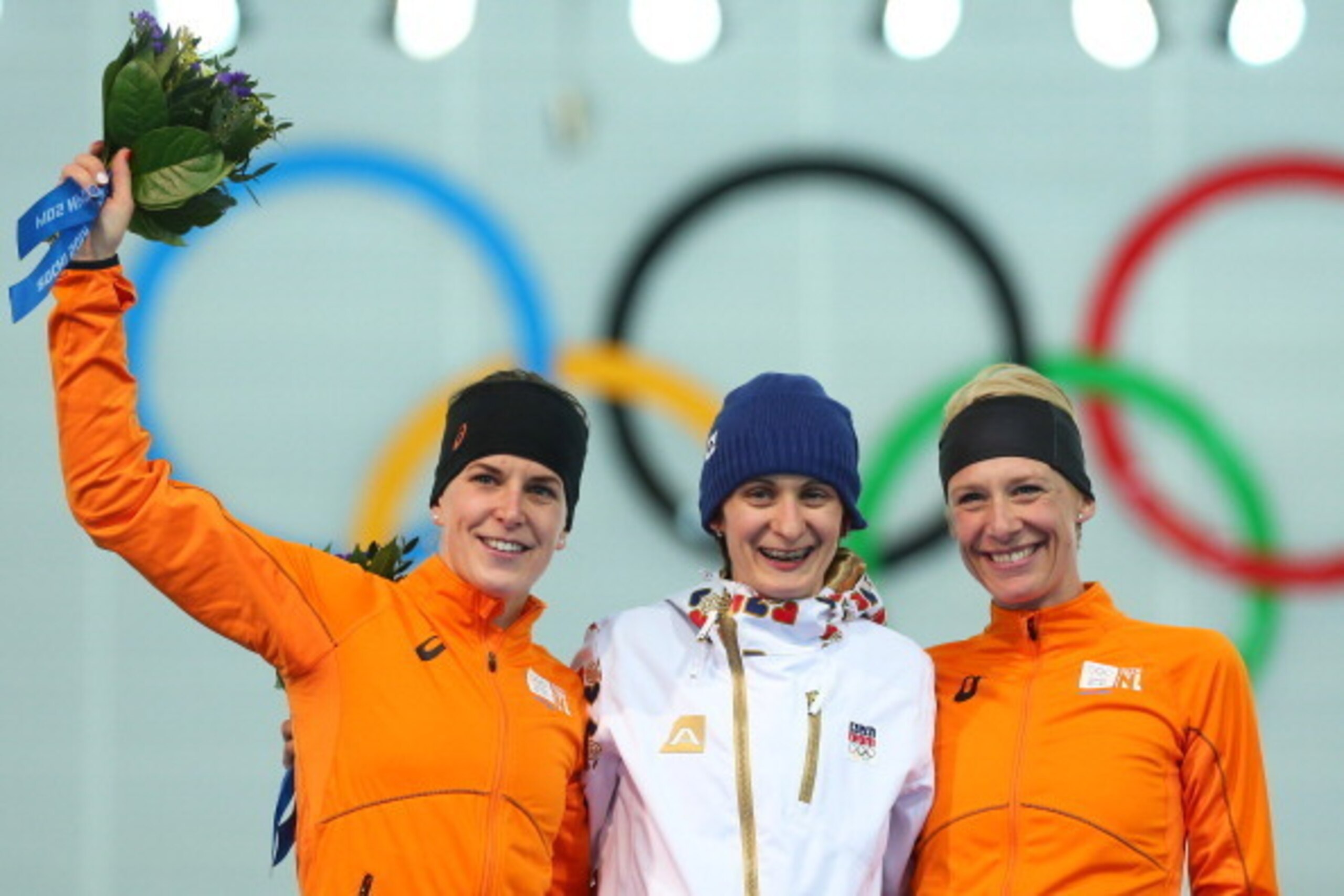 SOCHI, RUSSIA - FEBRUARY 19:  (L-R) Silver medalist Ireen Wust of the Netherlands, gold medalist Martina Sablikova of the Czech Republic and bronze medalist Carien Kleibeuker of the Netherlands celebrate on the podium during the flower ceremony for the Sp