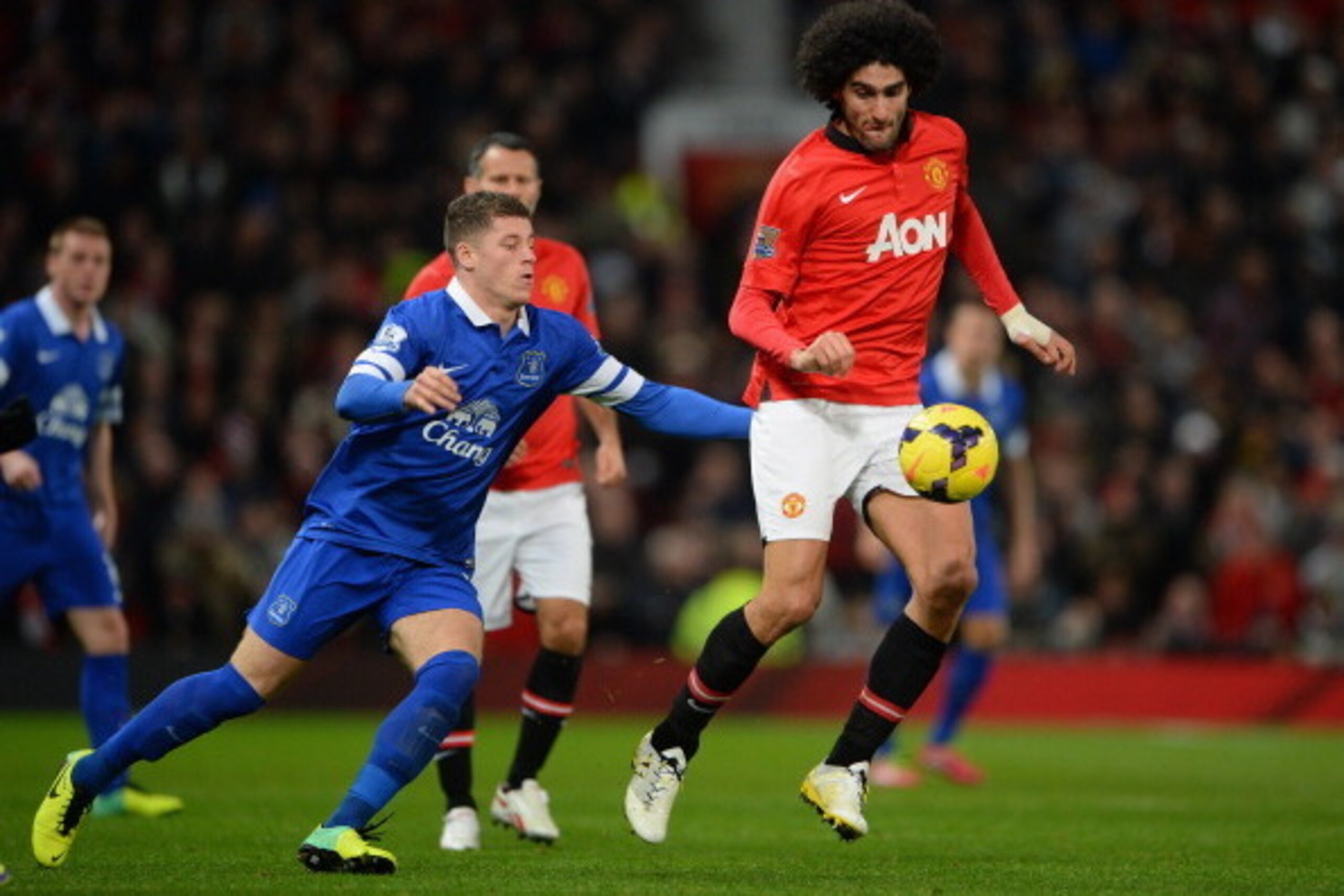 MANCHESTER, ENGLAND - DECEMBER 04:  Marouane Fellaini of Manchester United competes with Ross Barkley of Everton during the Barclays Premier League match between Manchester United and Everton at Old Trafford on December 4, 2013 in Manchester, England.  (P