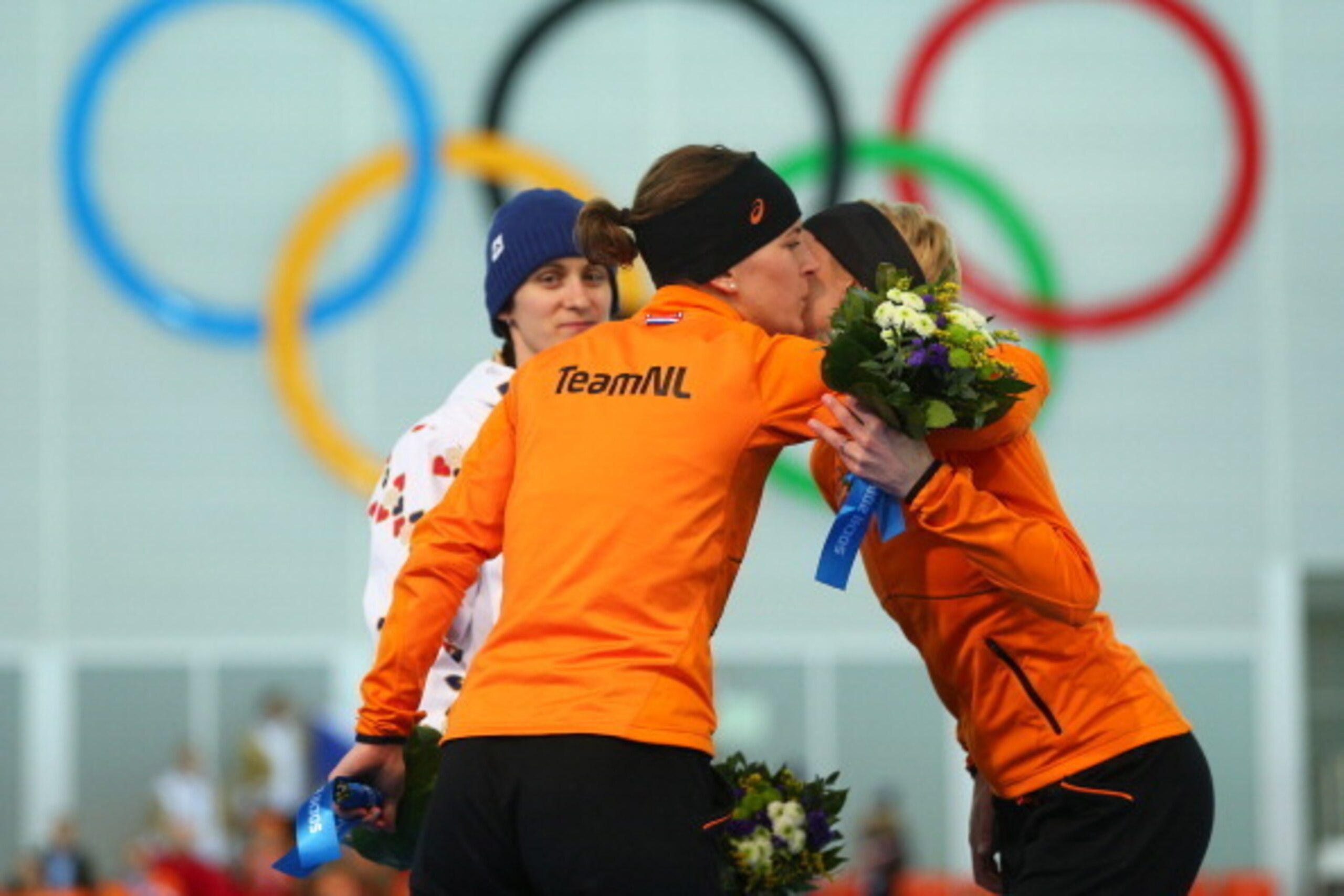 SOCHI, RUSSIA - FEBRUARY 19:  (L-R) Gold medalist Martina Sablikova of the Czech Republic, silver medalist Ireen Wust of the Netherlands and bronze medalist Carien Kleibeuker of the Netherlands celebrate on the podium during the flower ceremony for the Sp