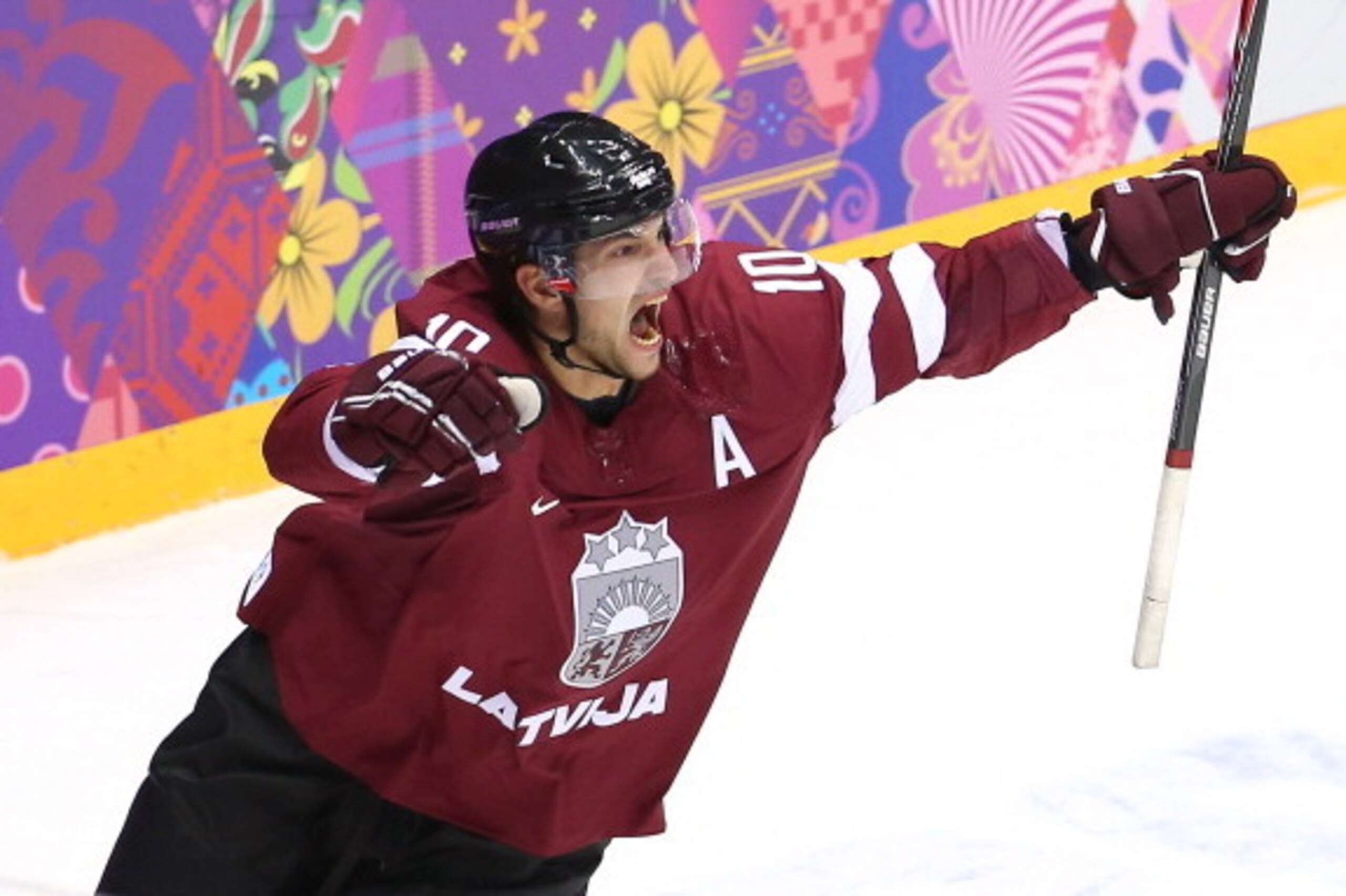 SOCHI, RUSSIA - FEBRUARY 19:  Lauris Darzins #10 of Latvia celebrates after scoring a first-period goal against Canada during the Men's Ice Hockey Quarterfinal Playoff on Day 12 of the 2014 Sochi Winter Olympics at Bolshoy Ice Dome on February 19, 2014 in