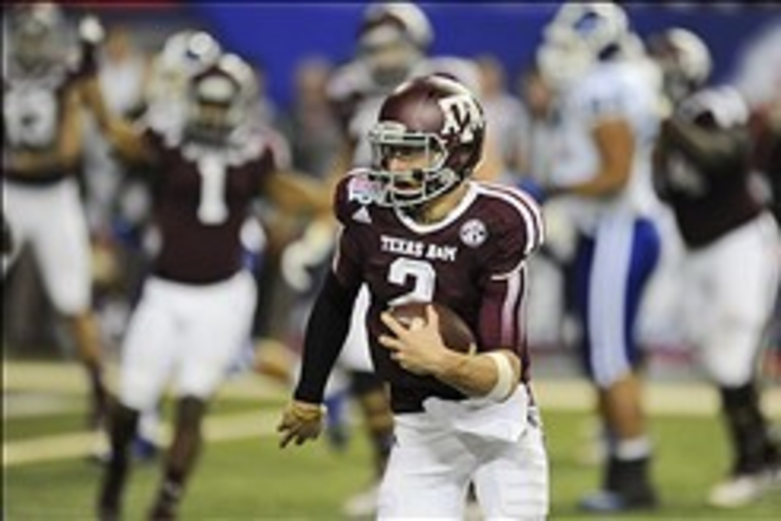 Dec 31, 2013; Atlanta, GA, USA;  Texas A&M Aggies quarterback Johnny Manziel (2) carries the ball for a three yard touchdown against the Duke Blue Devils in the 2013 Chick-fil-a Bowl at the Georgia Dome. Mandatory Credit: Dale Zanine-USA TODAY Sports