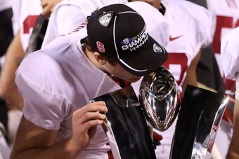 TEMPE, AZ - DECEMBER 07:  Quarterback Kevin Hogan #8 of the Stanford Cardinal celebrates by kissing the Pac 12 Championship trophy after defeating the Arizona State Sun Devils 38-14 at Sun Devil Stadium on December 7, 2013 in Tempe, Arizona.  (Photo by Ch