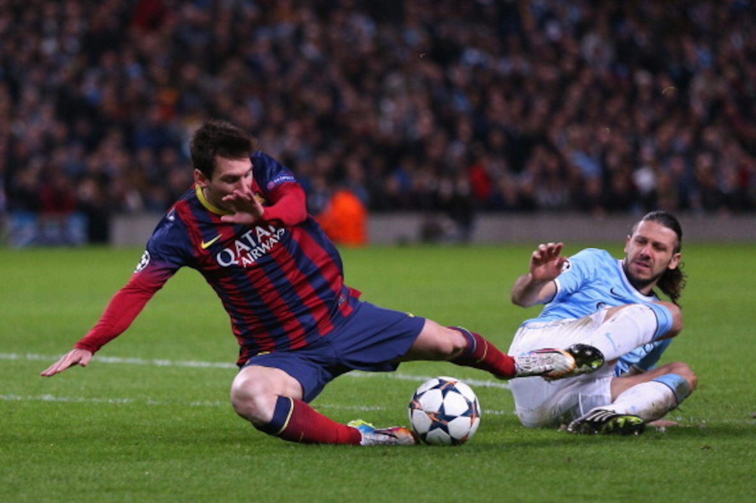 MANCHESTER, ENGLAND - FEBRUARY 18:  Martin Demichelis of Manchester City fouls Lionel Messi of Barcelona to concede a penalty and is subsequently sent off during the UEFA Champions League Round of 16 first leg match between Manchester City and Barcelona a