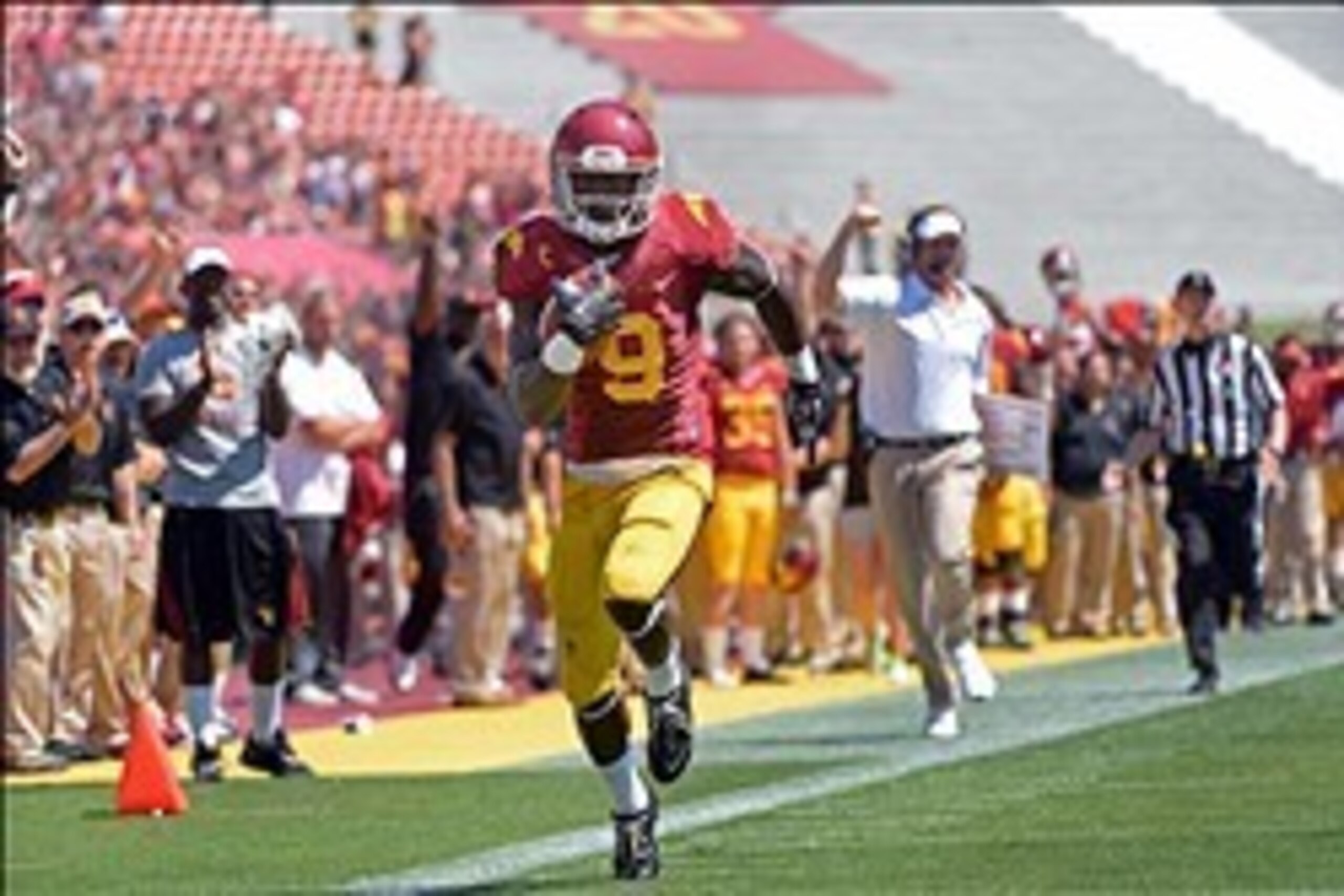 Sep 14, 2013; Los Angeles, CA, USA; USC Trojans wide receiver Marqise Lee (9) sprints down the sideline on his way to an 80-yard touchdown as he is trailed on the sidelines by head coach Lane Kiffin during the second quarter against Boston College at Los Sep 14, 2013; Los Angeles, CA, USA; USC Trojans wide receiver Marqise Lee (9) sprints down the sideline on his way to an 80-yard touchdown as he is trailed on the sidelines by head coach Lane Kiffin during the second quarter against Boston College at Los