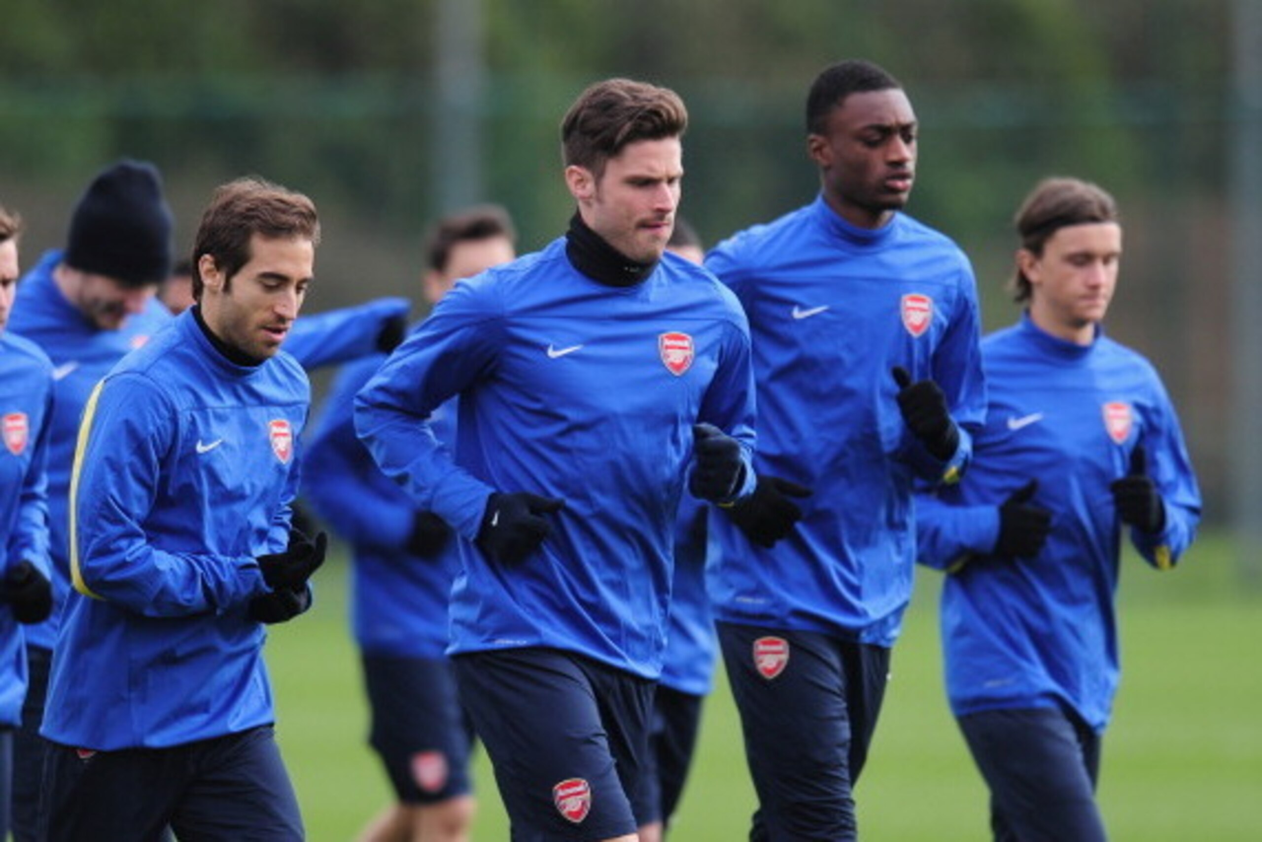ST ALBANS, ENGLAND - FEBRUARY 18:  Olivier Giroud and Mathieu Flamini warm up during a training session at London Colney on February 18, 2014 in St Albans, England.  (Photo by Shaun Botterill/Getty Images)
