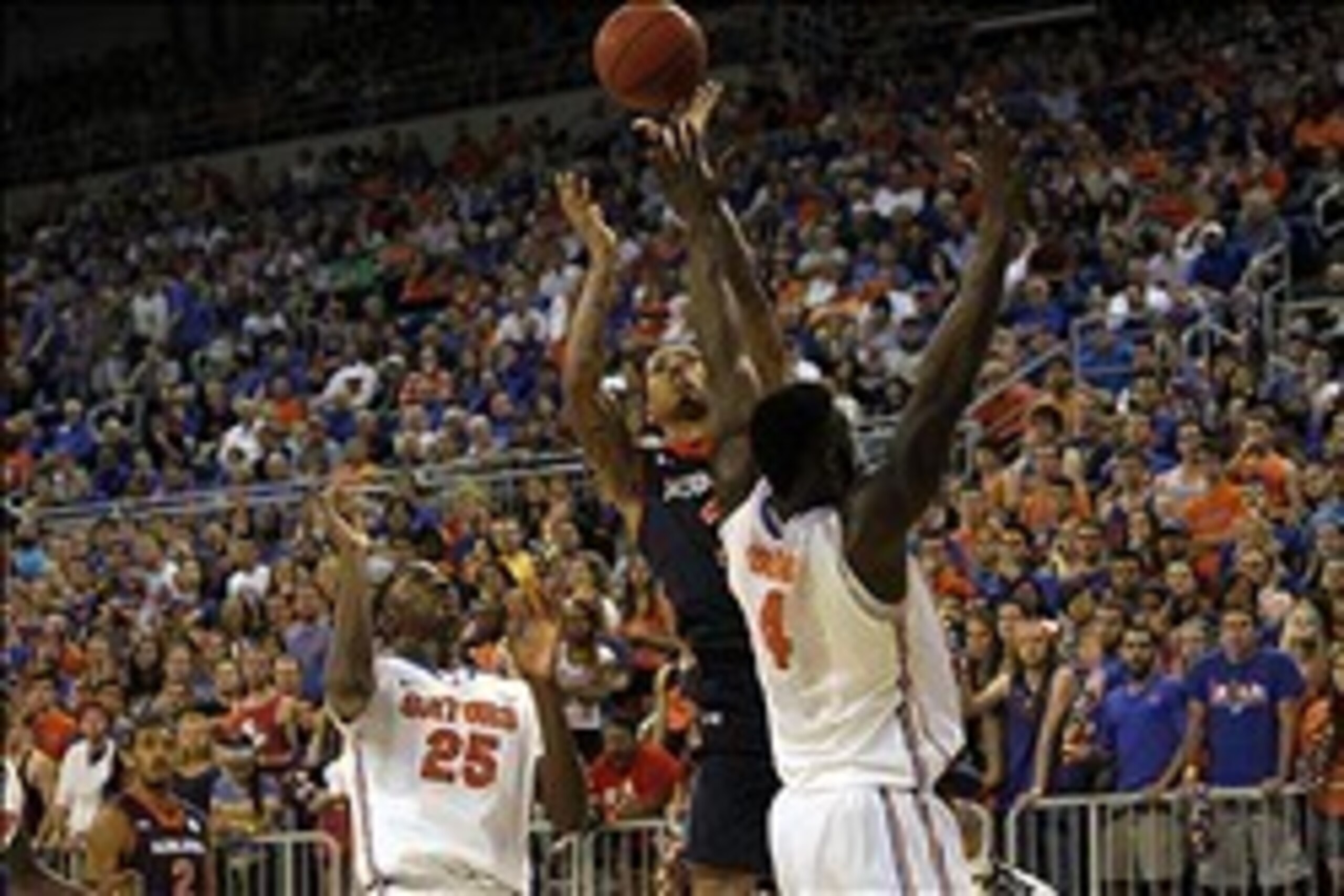 Feb 19, 2014; Gainesville, FL, USA; Auburn Tigers guard Chris Denson (3) shoots over Florida Gators center Patric Young (4) during the first half at Stephen C. O'Connell Center. Mandatory Credit: Kim Klement-USA TODAY Sports