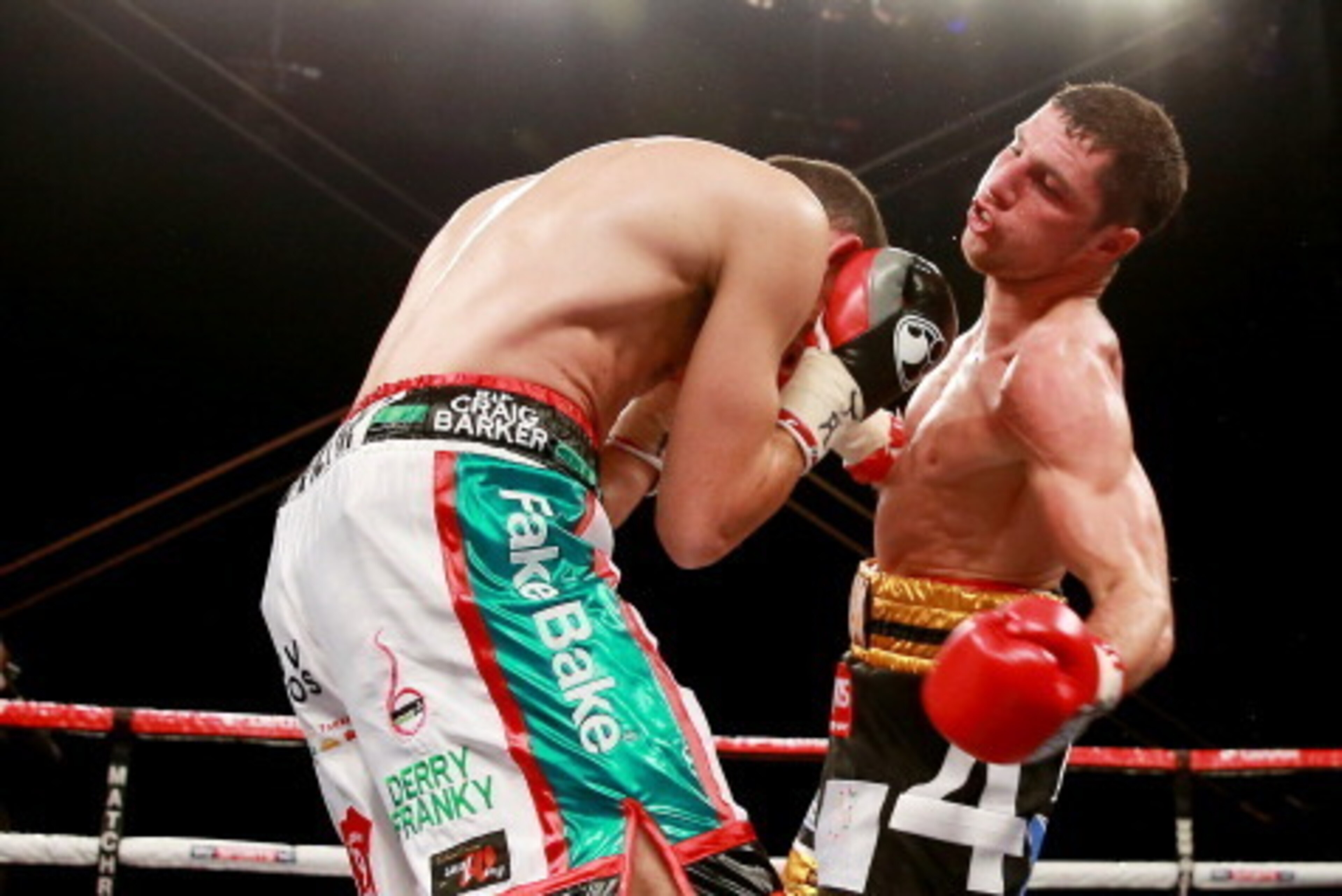 HULL, ENGLAND - JULY 13:  Derry Matthews (L) in action with Tommy Coyle during their Vacant Commonwealth Lightweight Championship bout at Craven Park Stadium on July 13, 2013 in Hull, England.  (Photo by Scott Heavey/Getty Images)