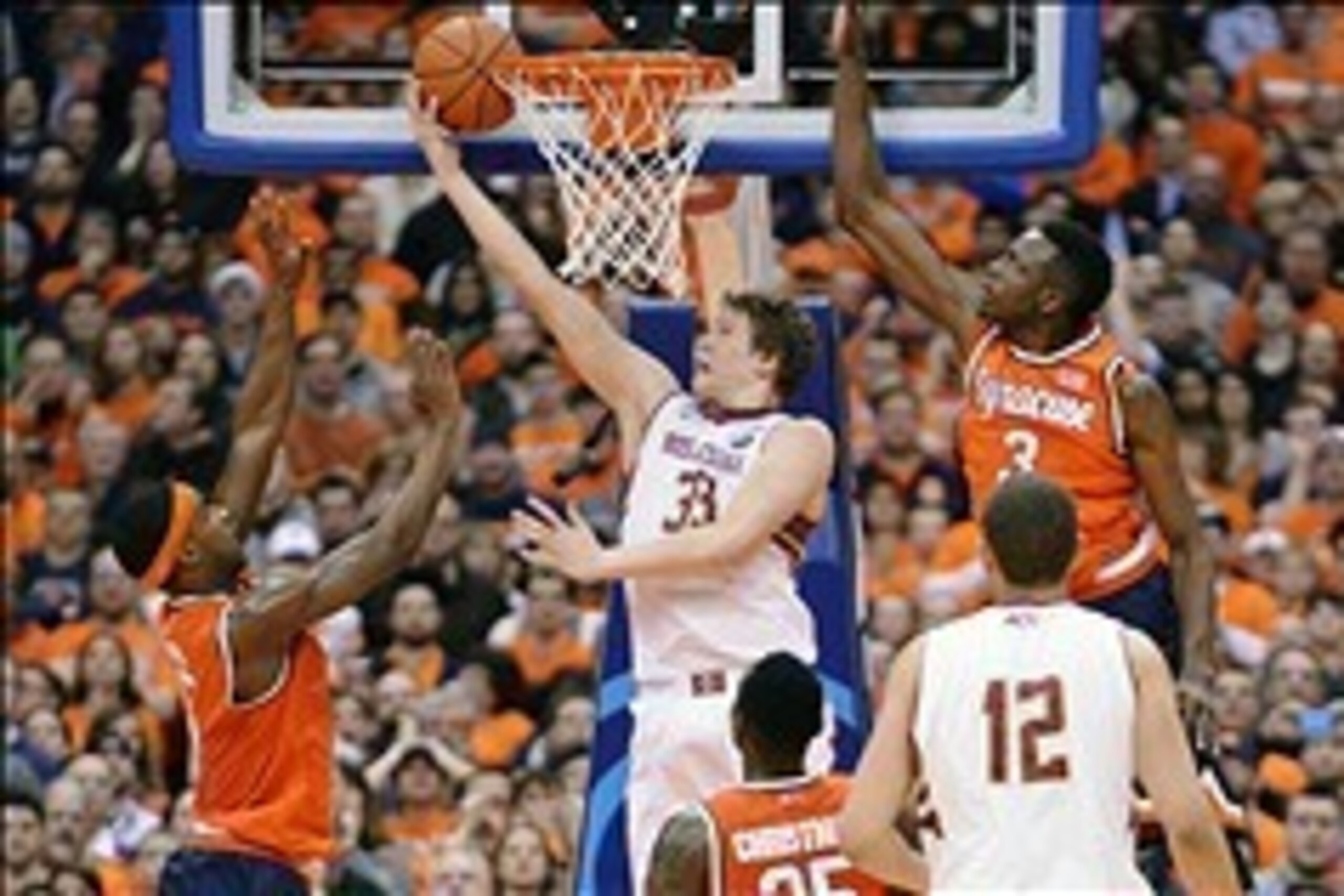 Feb 19, 2014; Syracuse, NY, USA; Boston College Eagles guard Patrick Heckmann (33) makes a shot under the basket with Syracuse Orange forward Jerami Grant (3) and forward C.J. Fair (left) defending during the second half of a game at the Carrier Dome. Bos Feb 19, 2014; Syracuse, NY, USA; Boston College Eagles guard Patrick Heckmann (33) makes a shot under the basket with Syracuse Orange forward Jerami Grant (3) and forward C.J. Fair (left) defending during the second half of a game at the Carrier Dome. Bos