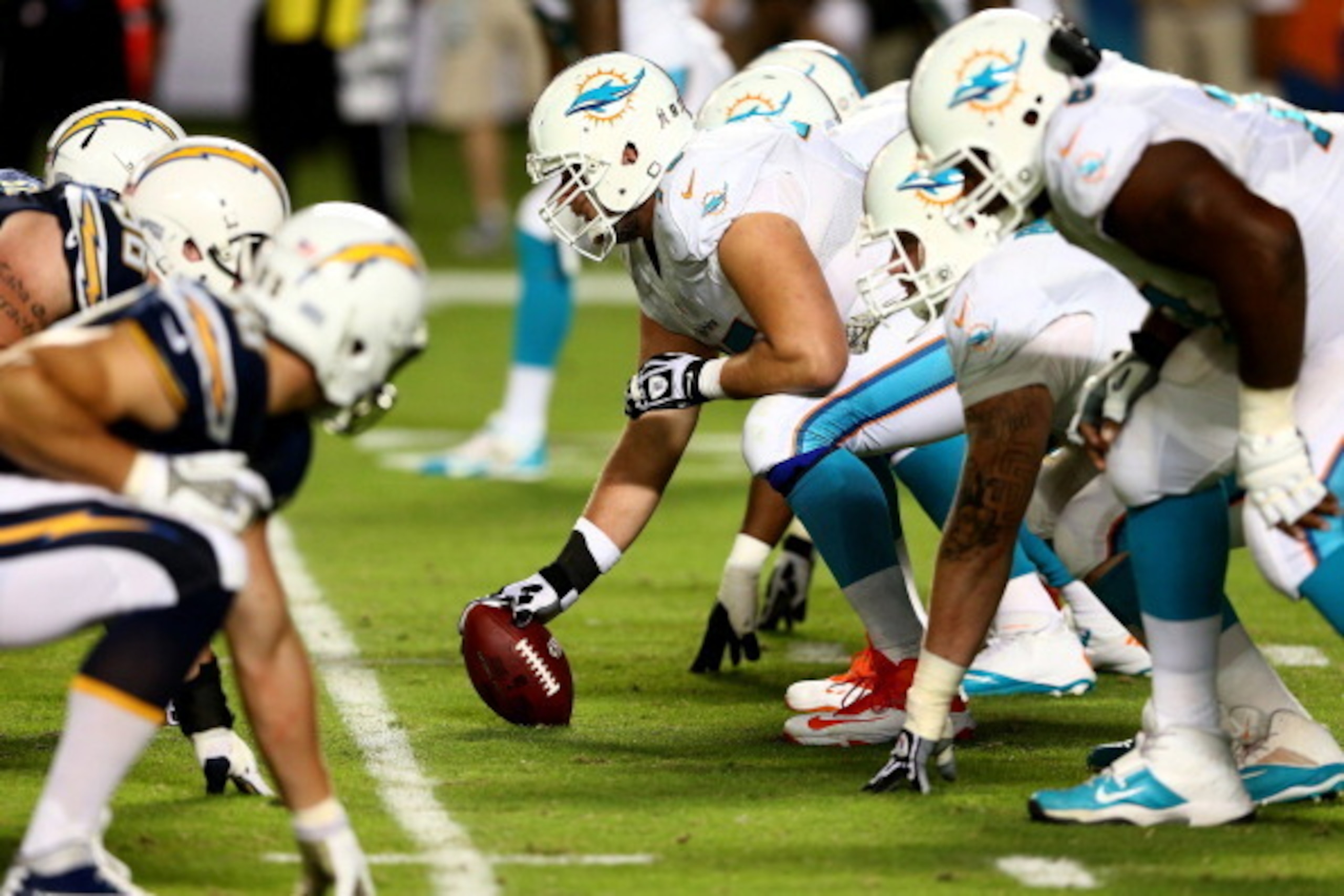 MIAMI GARDENS, FL - NOVEMBER 17:  The offensive line of the Miami Dolphins lines up for a play against the San Diego Chargers during their game at Sun Life Stadium on November 17, 2013 in Miami Gardens, Florida.  (Photo by Streeter Lecka/Getty Images)