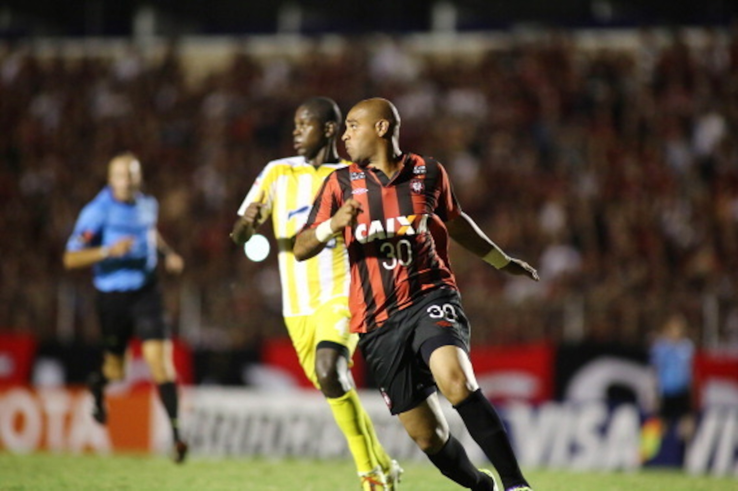 CURITIBA, PARANA, BRAZIL - FEBRUARY 13: Adriano (R) of Atletico Paranaense battles for the ball against Jefferson Lopez of The Strongest during a match between Atletico Paranaense and The Strongest as part of Copa Bridgestone Libertadores 2014 at Durival CURITIBA, PARANA, BRAZIL - FEBRUARY 13: Adriano (R) of Atletico Paranaense battles for the ball against Jefferson Lopez of The Strongest during a match between Atletico Paranaense and The Strongest as part of Copa Bridgestone Libertadores 2014 at Durival