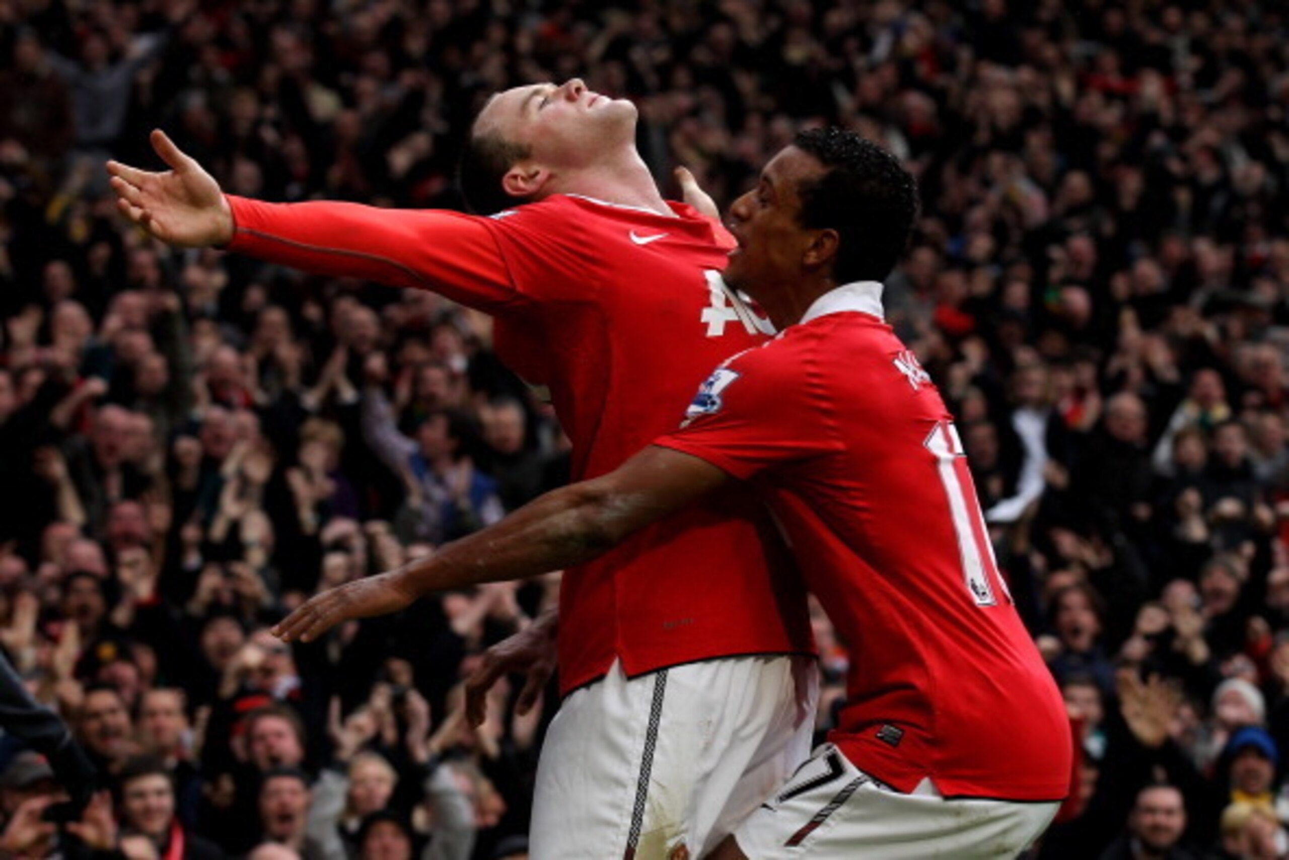 MANCHESTER, ENGLAND - FEBRUARY 12:  Wayne Rooney of Manchester United celebrates with teammate Nani (R) after he scores a goal from an overhead kick during the Barclays Premier League match between Manchester United and Manchester City at Old Trafford on 
