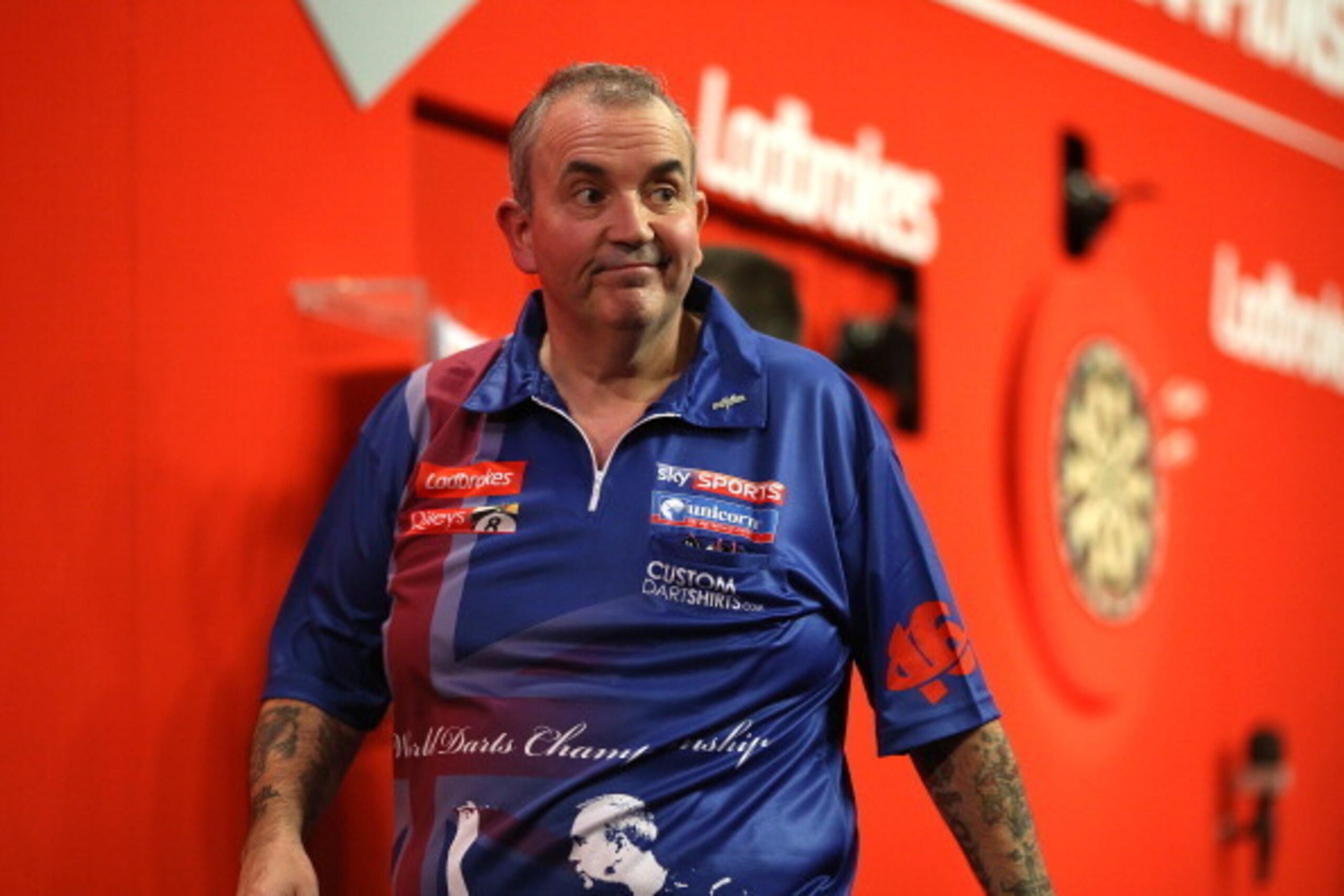LONDON, ENGLAND - DECEMBER 20: Phil Taylor of England reacts as he walks off the stage after losing his second round match to Michael Smith of England during the Ladbrokes.com World Darts Championship on Day Eight at Alexandra Palace on December 20, 2013 LONDON, ENGLAND - DECEMBER 20: Phil Taylor of England reacts as he walks off the stage after losing his second round match to Michael Smith of England during the Ladbrokes.com World Darts Championship on Day Eight at Alexandra Palace on December 20, 2013