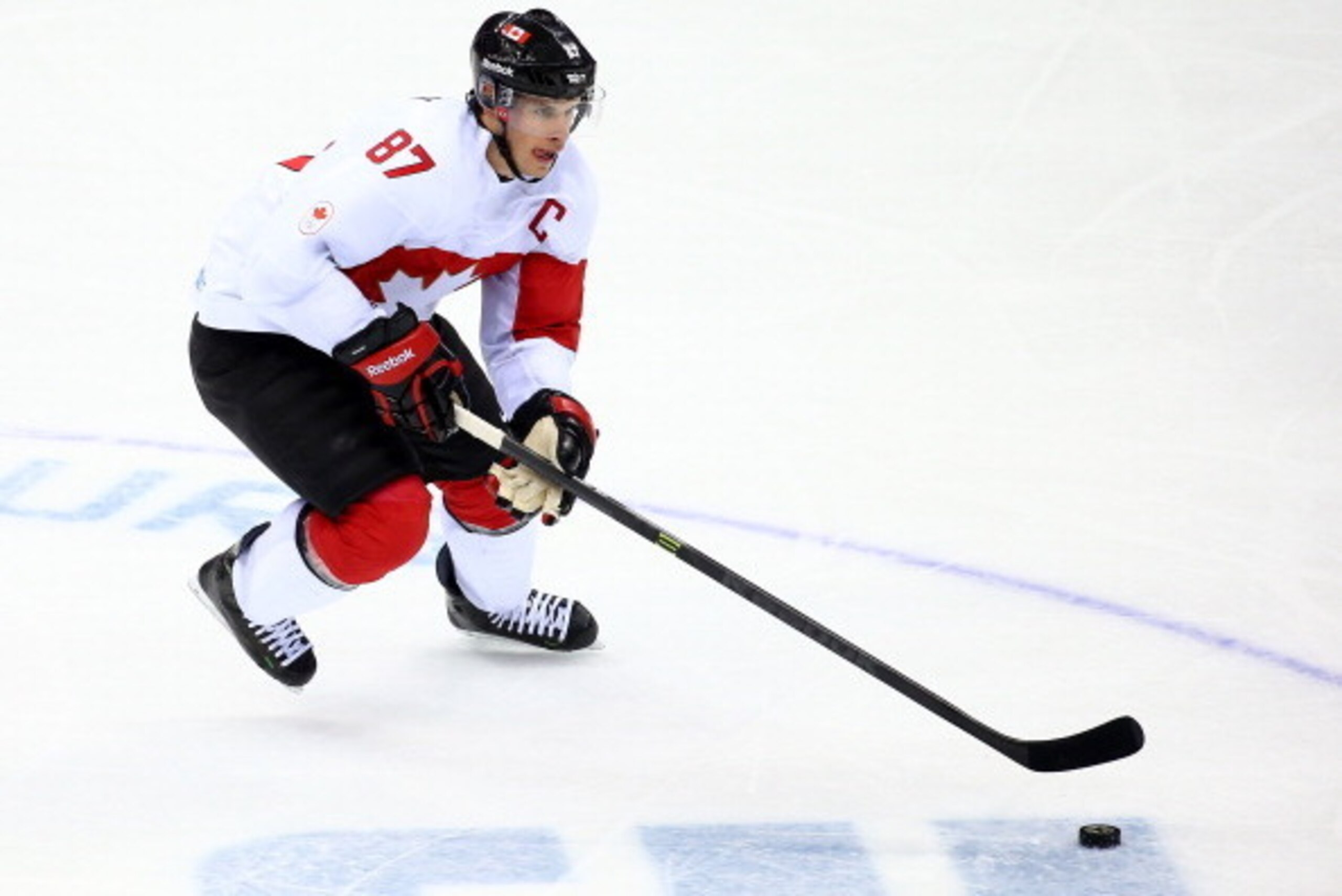 SOCHI, RUSSIA - FEBRUARY 19:  Sidney Crosby #87 of Canada controls the puck against Latvia during the Men's Ice Hockey Quarterfinal Playoff on Day 12 of the 2014 Sochi Winter Olympics at Bolshoy Ice Dome on February 19, 2014 in Sochi, Russia.  (Photo by S