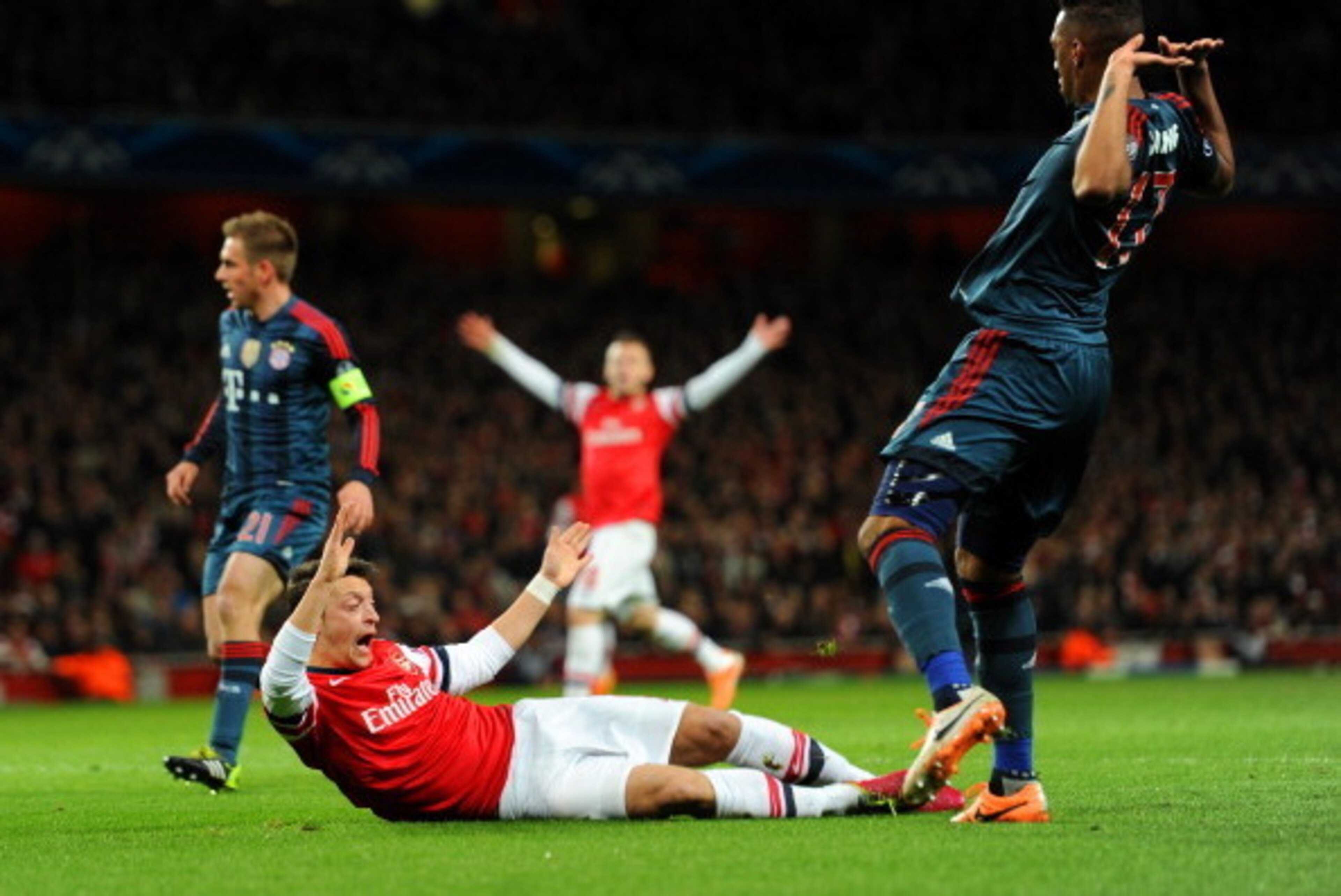 LONDON, ENGLAND - FEBRUARY 19:  Jerome Boateng of Bayern Muenchen brings down Mesut Oezil of Arsenal in the area for a penalty during the UEFA Champions League Round of 16 first leg match between Arsenal and FC Bayern Muenchen at Emirates Stadium on Febru
