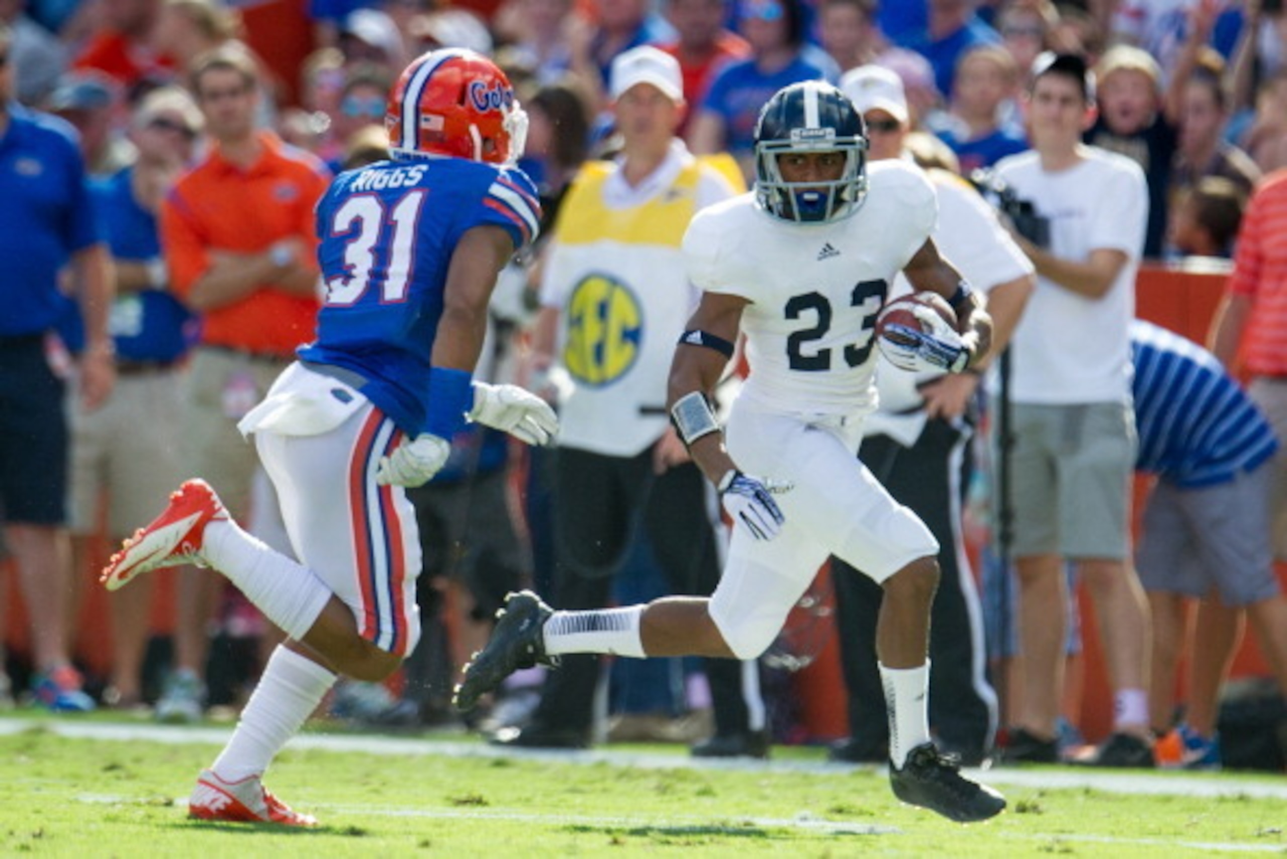 GAINESVILLE, FL - NOVEMBER 23: Wide receiver Johnathan Bryant #23 of the Georgia Southern Eagles looks to maneuver by defensive back Cody Riggs #31 of the Florida Gators on November 23, 2013 at Ben Hill Griffin Stadium in Gainesville, Florida. Georgia So GAINESVILLE, FL - NOVEMBER 23: Wide receiver Johnathan Bryant #23 of the Georgia Southern Eagles looks to maneuver by defensive back Cody Riggs #31 of the Florida Gators on November 23, 2013 at Ben Hill Griffin Stadium in Gainesville, Florida. Georgia So