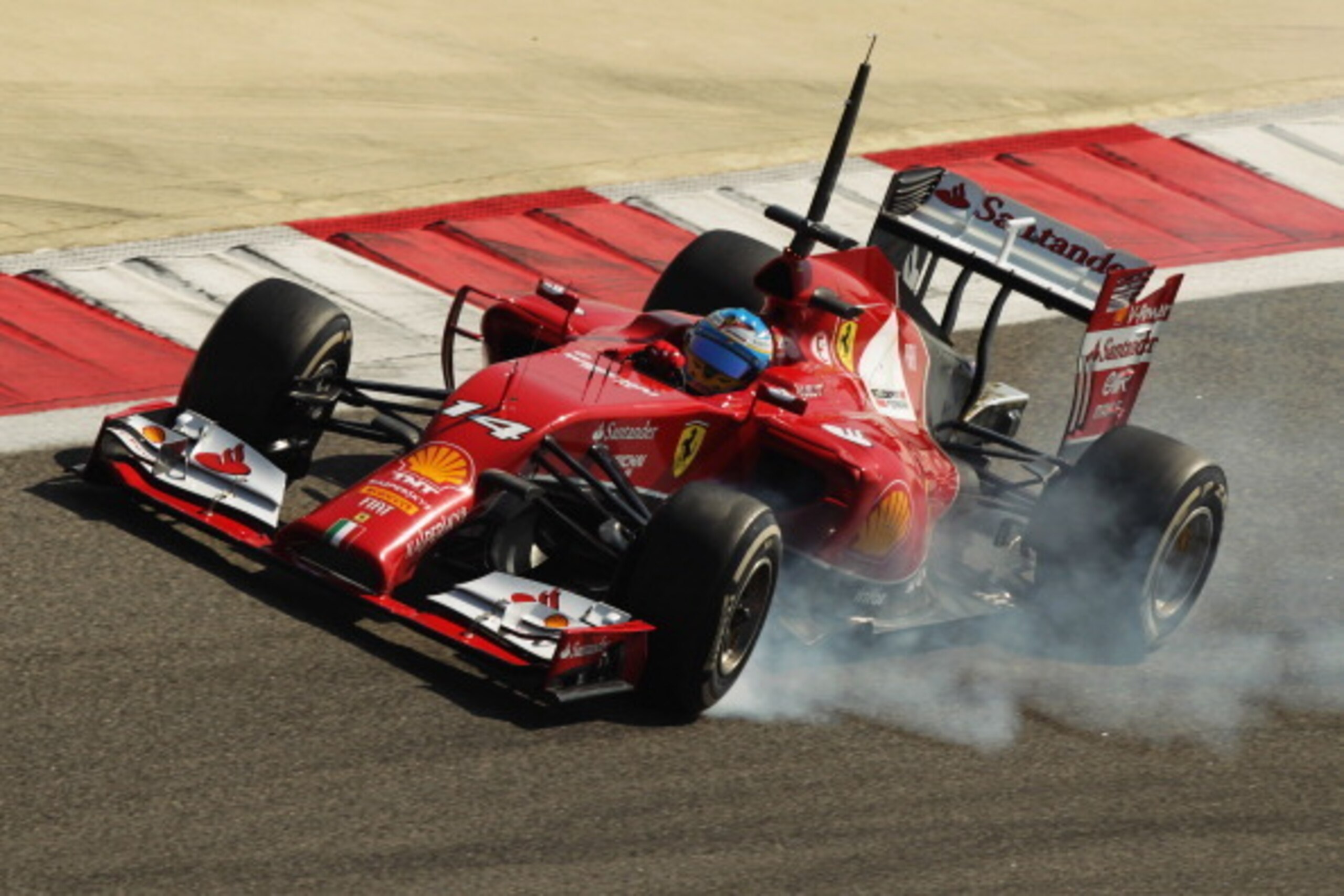 BAHRAIN, BAHRAIN - FEBRUARY 20:  Fernando Alonso of Spain and Ferrari locks up while he drives during day two of Formula One Winter Testing at the Bahrain International Circuit on February 20, 2014 in Bahrain, Bahrain.  (Photo by Ker Robertson/Getty Image