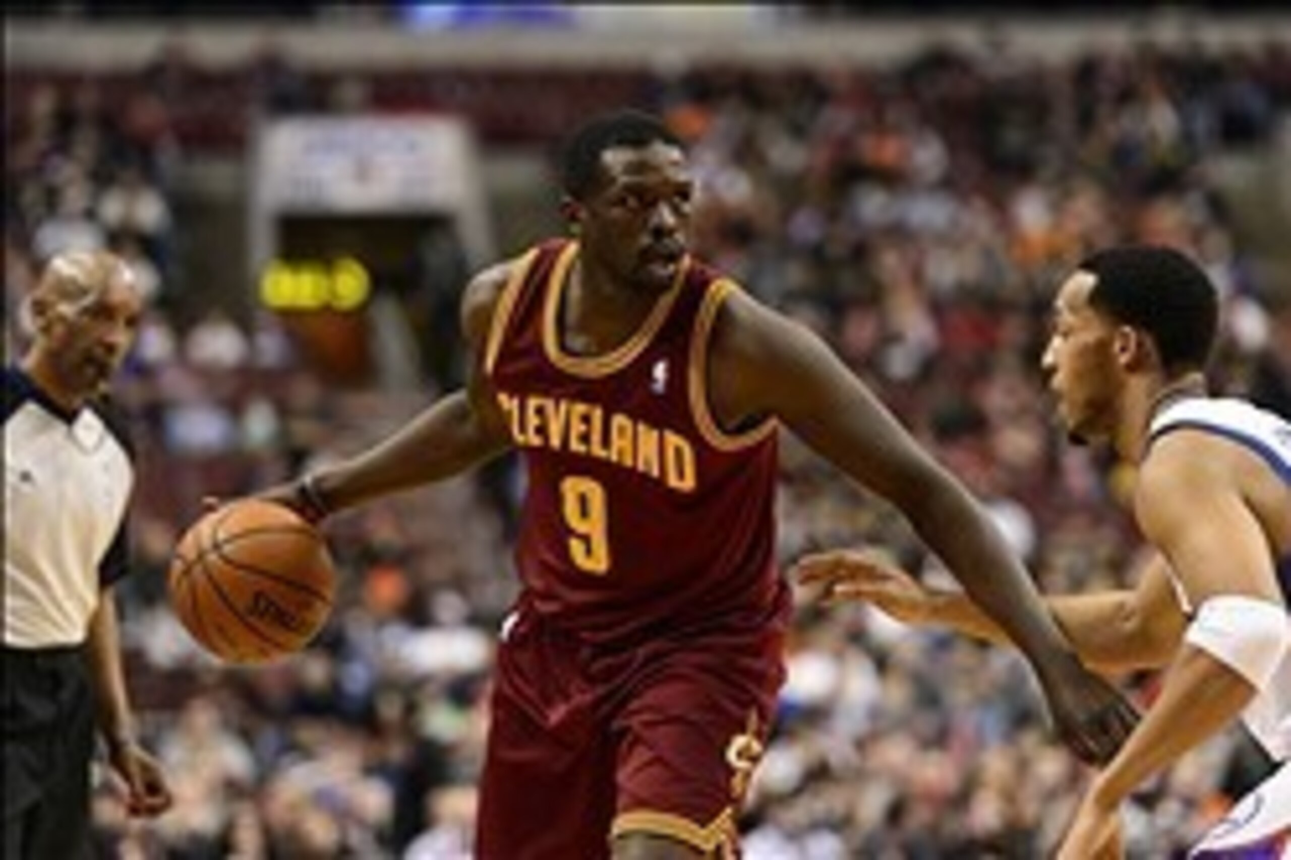 Feb 18, 2014; Philadelphia, PA, USA; Cleveland Cavaliers forward Luol Deng (9) is defended by Philadelphia 76ers guard Evan Turner (12) during the first quarter at the Wells Fargo Center. Mandatory Credit: Howard Smith-USA TODAY Sports