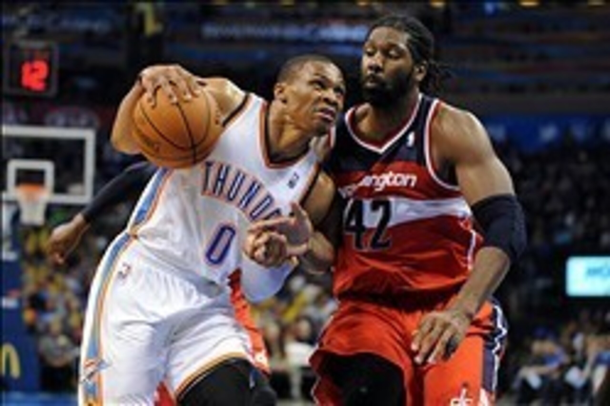 Nov 10, 2013; Oklahoma City, OK, USA; Oklahoma City Thunder point guard Russell Westbrook (0) handles the ball against Washington Wizards power forward Nene Hilario (42) during the fourth quarter at Chesapeake Energy Arena. Mandatory Credit: Mark D. Smith