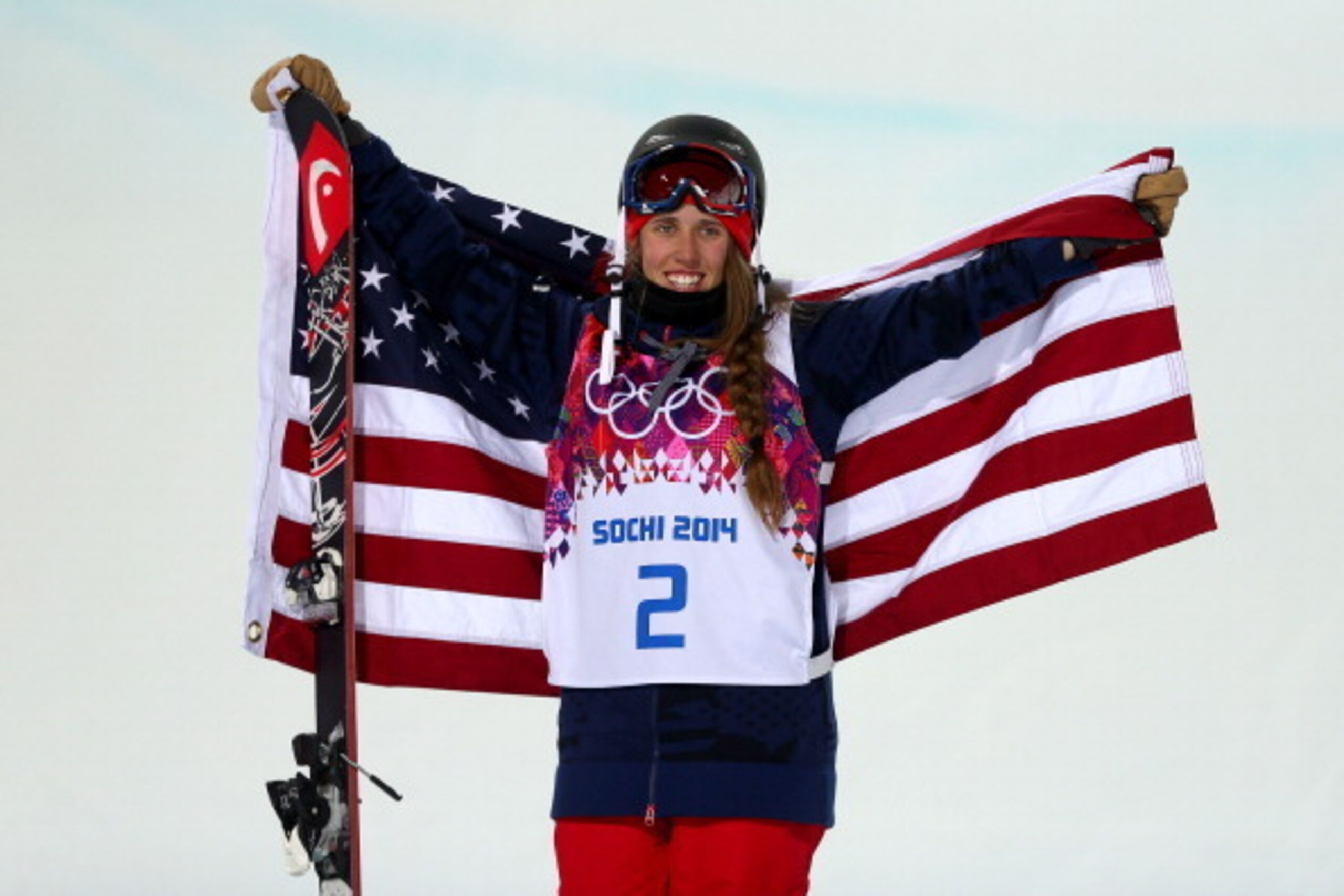 SOCHI, RUSSIA - FEBRUARY 20:  Gold medalist Maddie Bowman of the United States celebrates during the flower ceremony in the Freestyle Skiing Ladies' Ski Halfpipe Finals on day thirteen of the 2014 Winter Olympics at Rosa Khutor Extreme Park on February 20