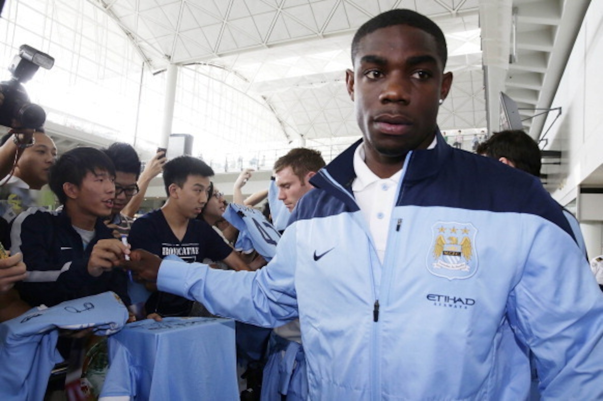 HONG KONG - JULY 22:  Manchester City player Micah Richards is greeted by fans at Hong Kong Airport as the team arrives to compete in the Barclays Asia Trophy, on July 22, 2013 in Hong Kong. (Photo by Jessica Hromas/Getty Images)