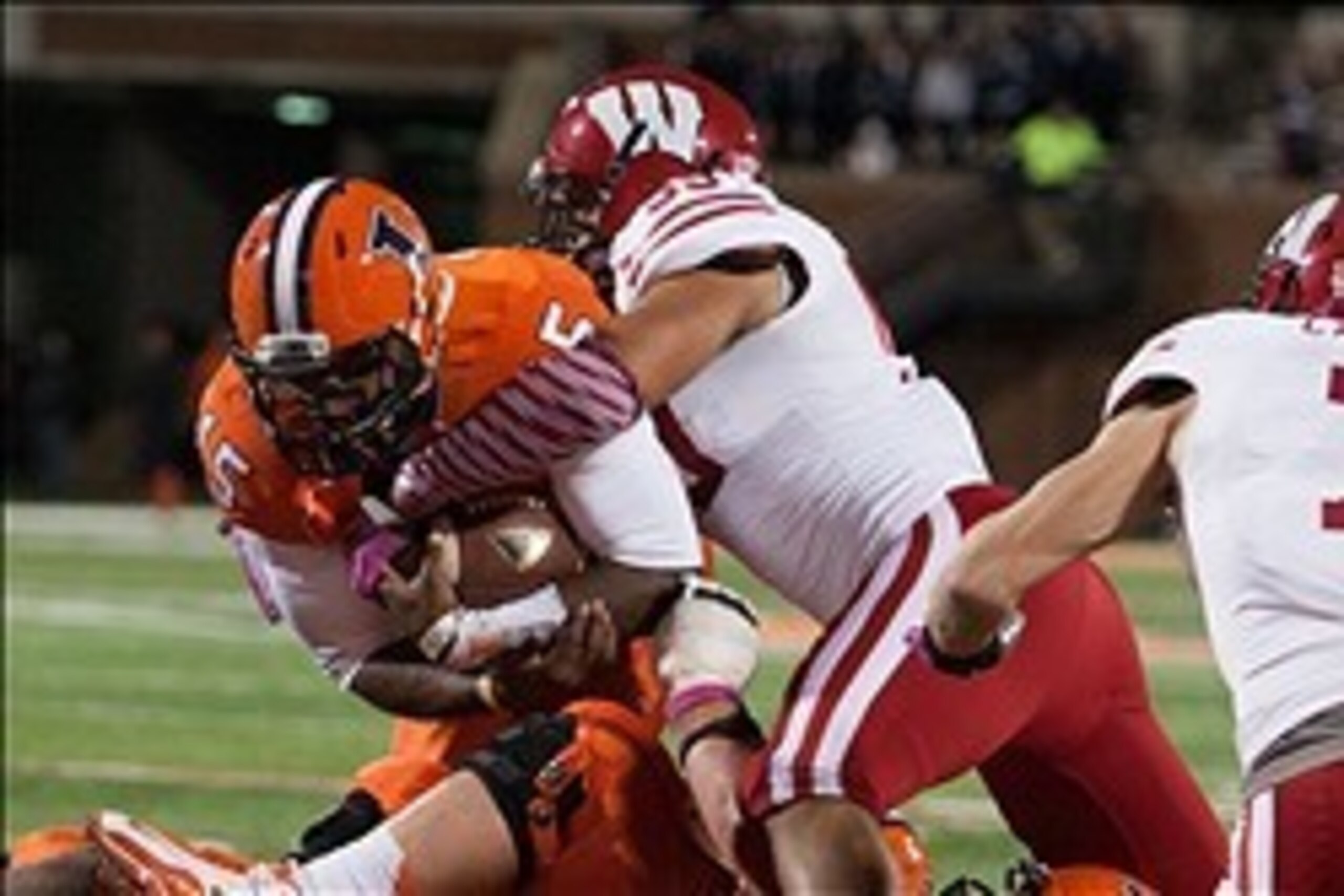 Oct 19, 2013; Champaign, IL, USA;  Illinois Fighting Illini quarterback Aaron Bailey (15) is tackled by Wisconsin Badgers linebacker Marcus Trotter (59) during the third quarter at Memorial Stadium. Wisconsin wins 56-32 over Illinois. Mandatory Credit: Tr