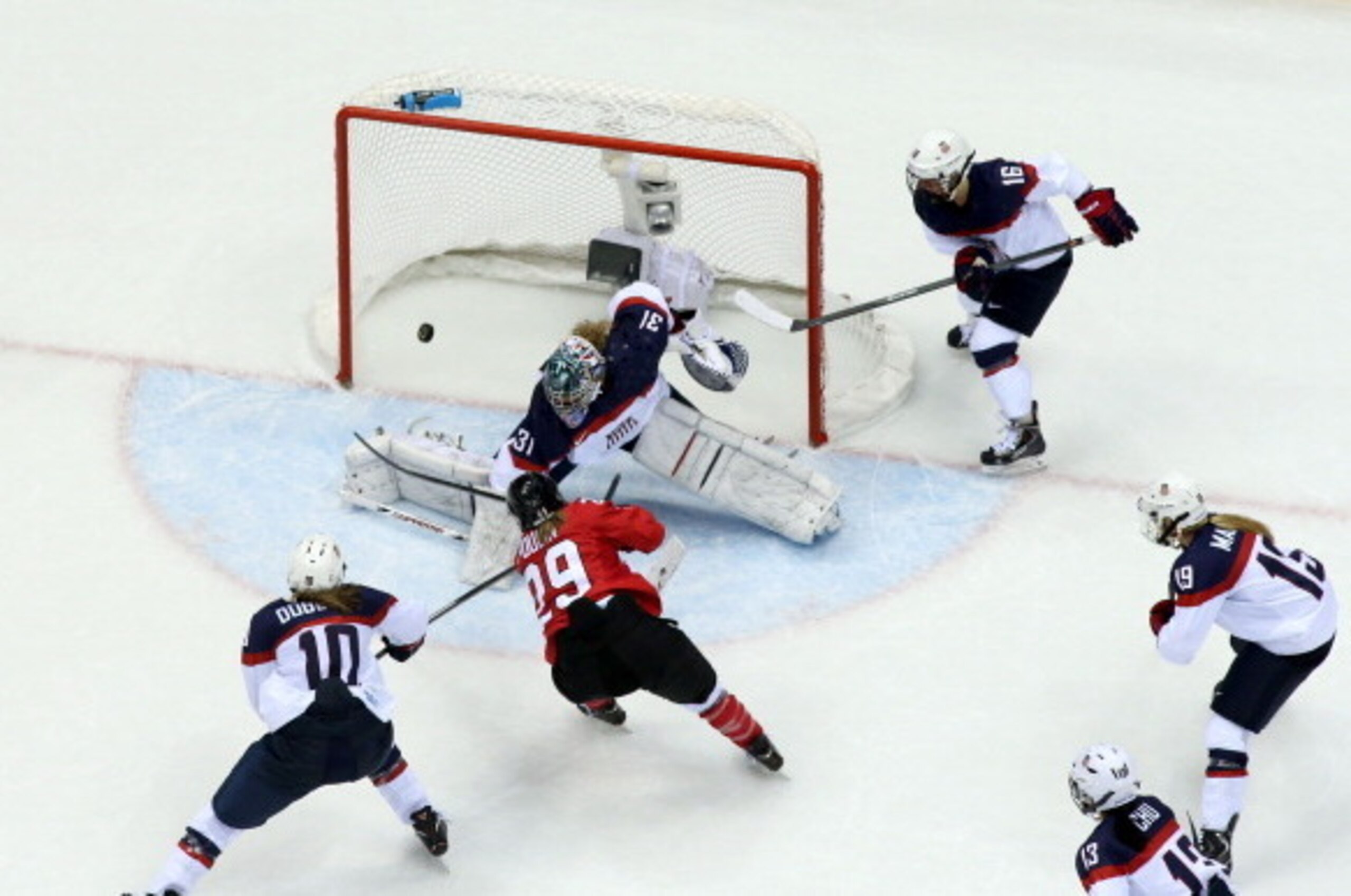 SOCHI, RUSSIA - FEBRUARY 20:   Marie-Philip Poulin #29 of Canada scores a third-period goal against Jessie Vetter #31 of the United States during the Ice Hockey Women's Gold Medal Game on day 13 of the Sochi 2014 Winter Olympics at Bolshoy Ice Dome on Feb