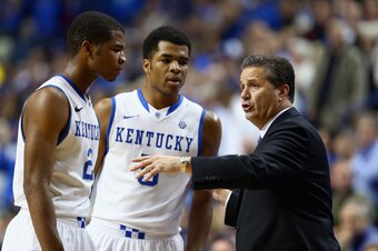 LEXINGTON, KY - NOVEMBER 25:  John Calipari the head coach of the Kentucky Wildcats talks with Aaron Harrison #2 and Andrew Harrison #5 during the game against the Cleveland State Vikings at Rupp Arena on November 25, 2013 in Lexington, Kentucky.  (Photo