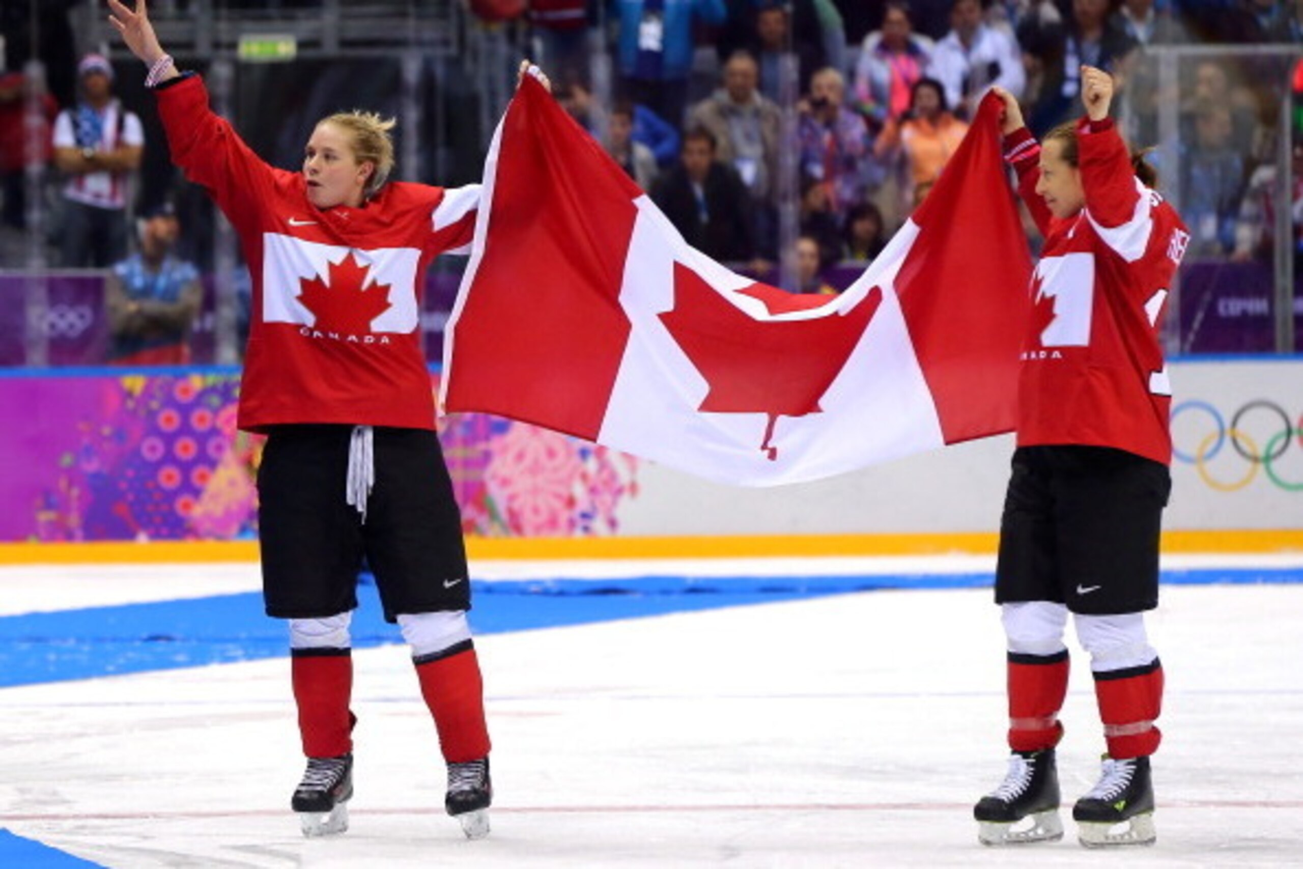 SOCHI, RUSSIA - FEBRUARY 20:  Meghan Agosta-Marciano #2 and Jayna Hefford #16 of Canada celebrate after defeating the United States 3-2 in overtime during the Ice Hockey Women's Gold Medal Game on day 13 of the Sochi 2014 Winter Olympics at Bolshoy Ice Do