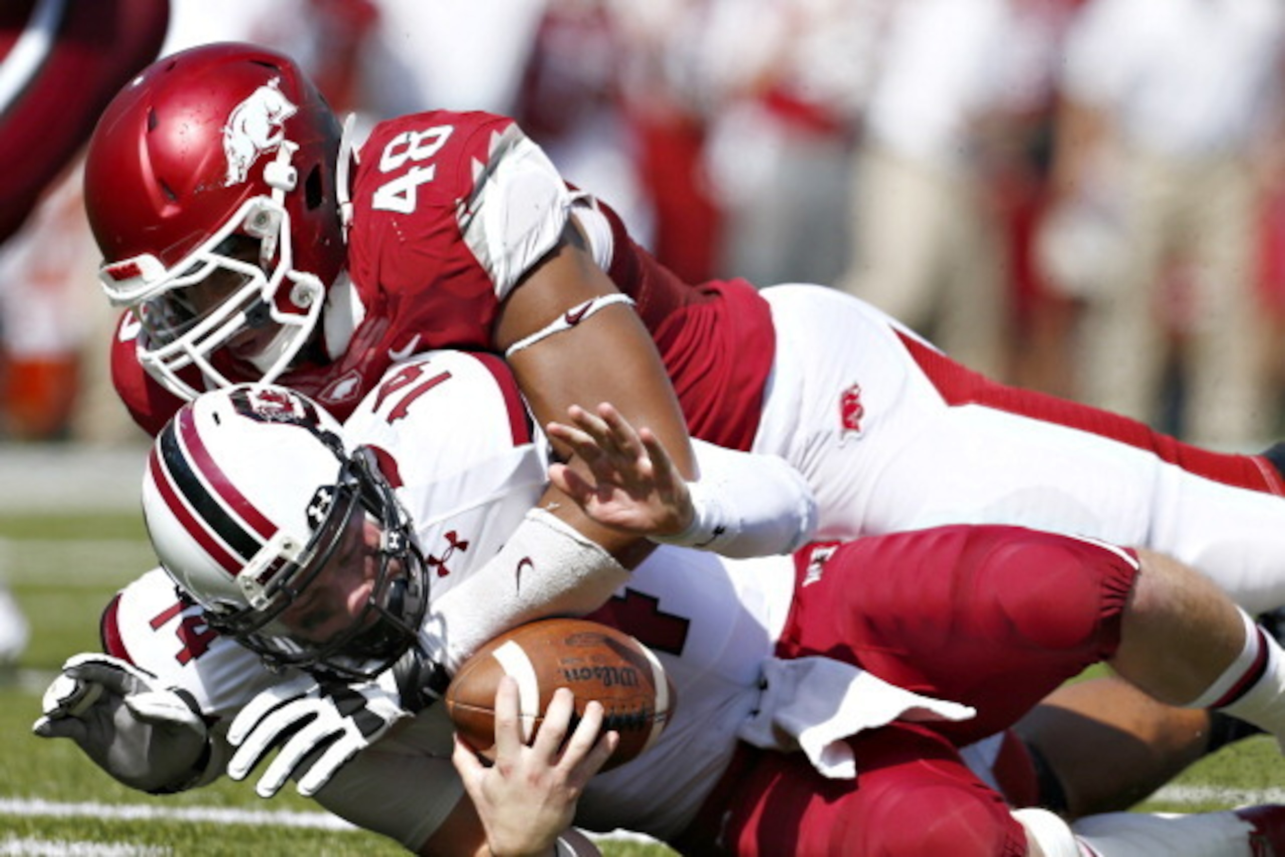 FAYETTEVILLE, AR - OCTOBER 12: Connor Shaw #14 of the South Carolina Gamecocks is sacked by Deatrich Wise Jr. #48 of the Arkansas Razorbacks at Razorback Stadium on October 12, 2013 in Fayetteville, Arkansas. (Photo by Wesley Hitt/Getty Images) FAYETTEVILLE, AR - OCTOBER 12: Connor Shaw #14 of the South Carolina Gamecocks is sacked by Deatrich Wise Jr. #48 of the Arkansas Razorbacks at Razorback Stadium on October 12, 2013 in Fayetteville, Arkansas. (Photo by Wesley Hitt/Getty Images)