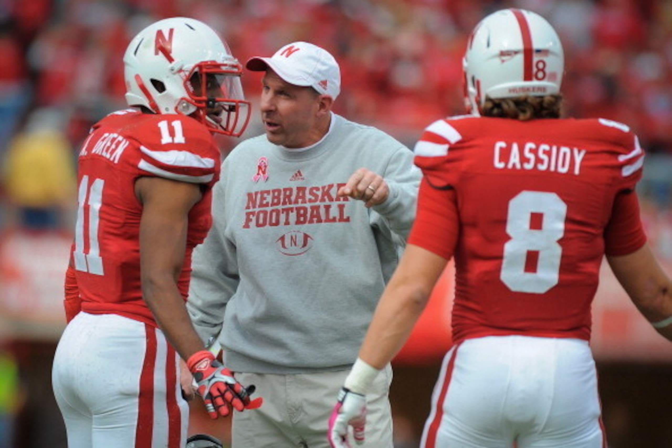LINCOLN, NE - OCTOBER 29: Nebraska Cornhuskers coach Bo Pelini talk to cornerback Andrew Green #11 and safety Austin Cassidy #8 of the Nebraska Cornhuskers during their game against the Michigan State Spartans at Memorial Stadium October 29, 2011 in Linco