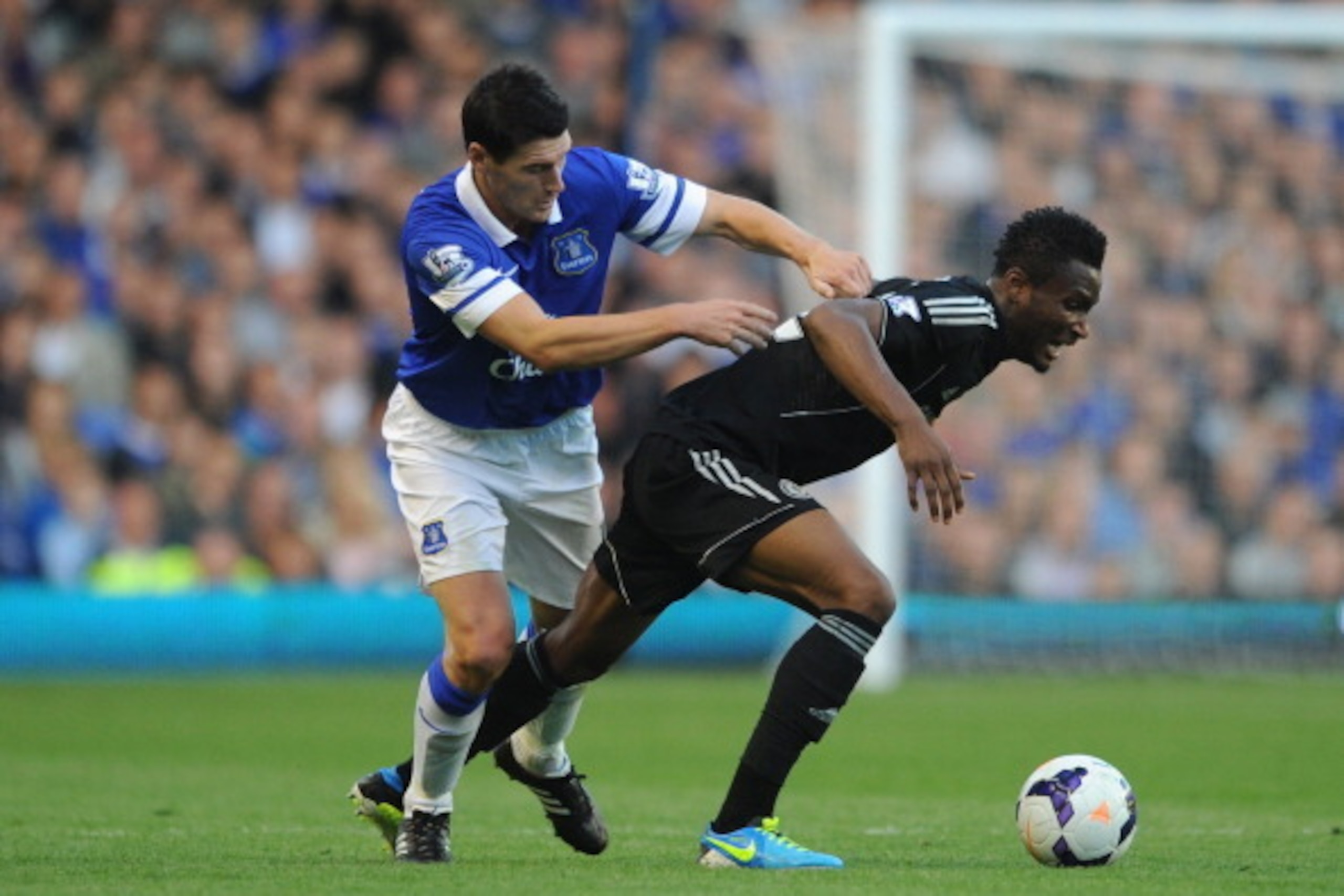LIVERPOOL, ENGLAND - SEPTEMBER 14:  John Obi Mikel of Chelsea tangles with Gareth Barry of Everton  during the Barclays Premier League match between Everton and Chelsea at Goodison Park on September 14, 2013 in Liverpool, England.  (Photo by Chris Brunski