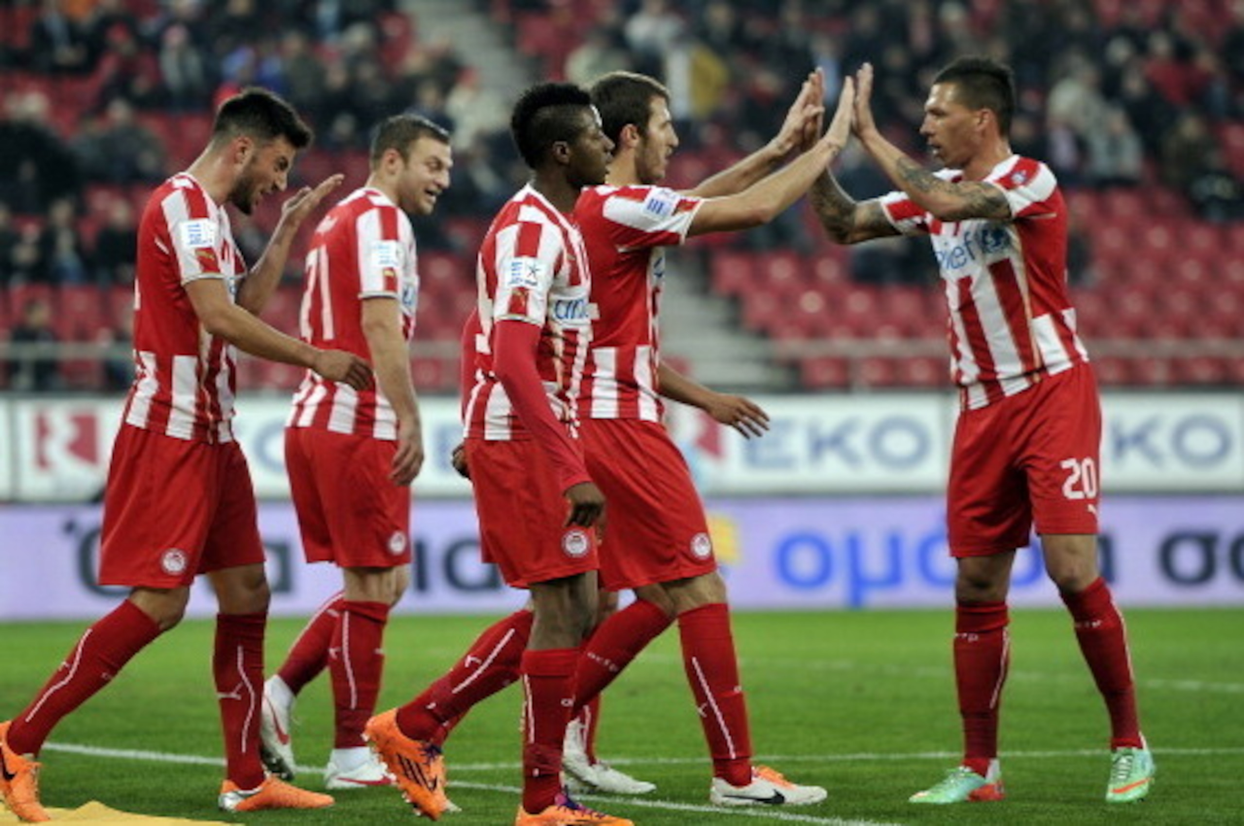 ATHENS,GREECE - FEBRUARY 5:  Olympiacos F.C. players celebrate during the Greek Superleague  match between Olympiacos F.C. and Panionios GSS at the Karaiskaki Stadium on February  5, 2014 in Piraeus near Athens. (Photo by Milos Bicanski/EuroFootball/Getty