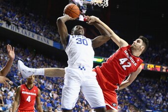 LEXINGTON, KY - JANUARY 25:  Julius Randle #30 of the Kentucky Wildcats shoots the ball while defended by Nemanja Djurisic #42 of the Georgia Bulldogs during the game at Rupp Arena on January 25, 2014 in Lexington, Kentucky.  (Photo by Andy Lyons/Getty Im