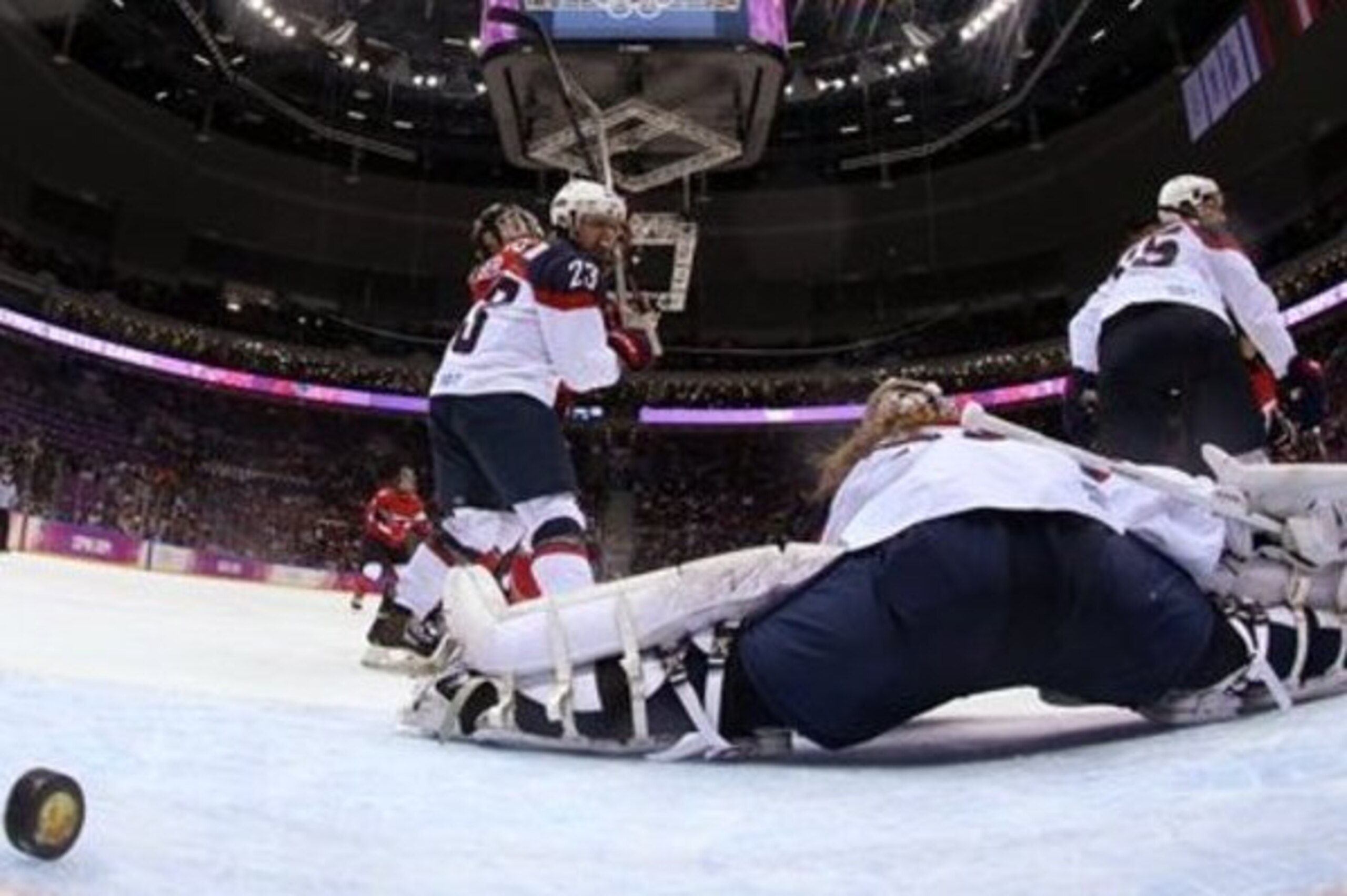 The game-winning goal, and gold, slips by U.S. goaltender Jessie Vetter.