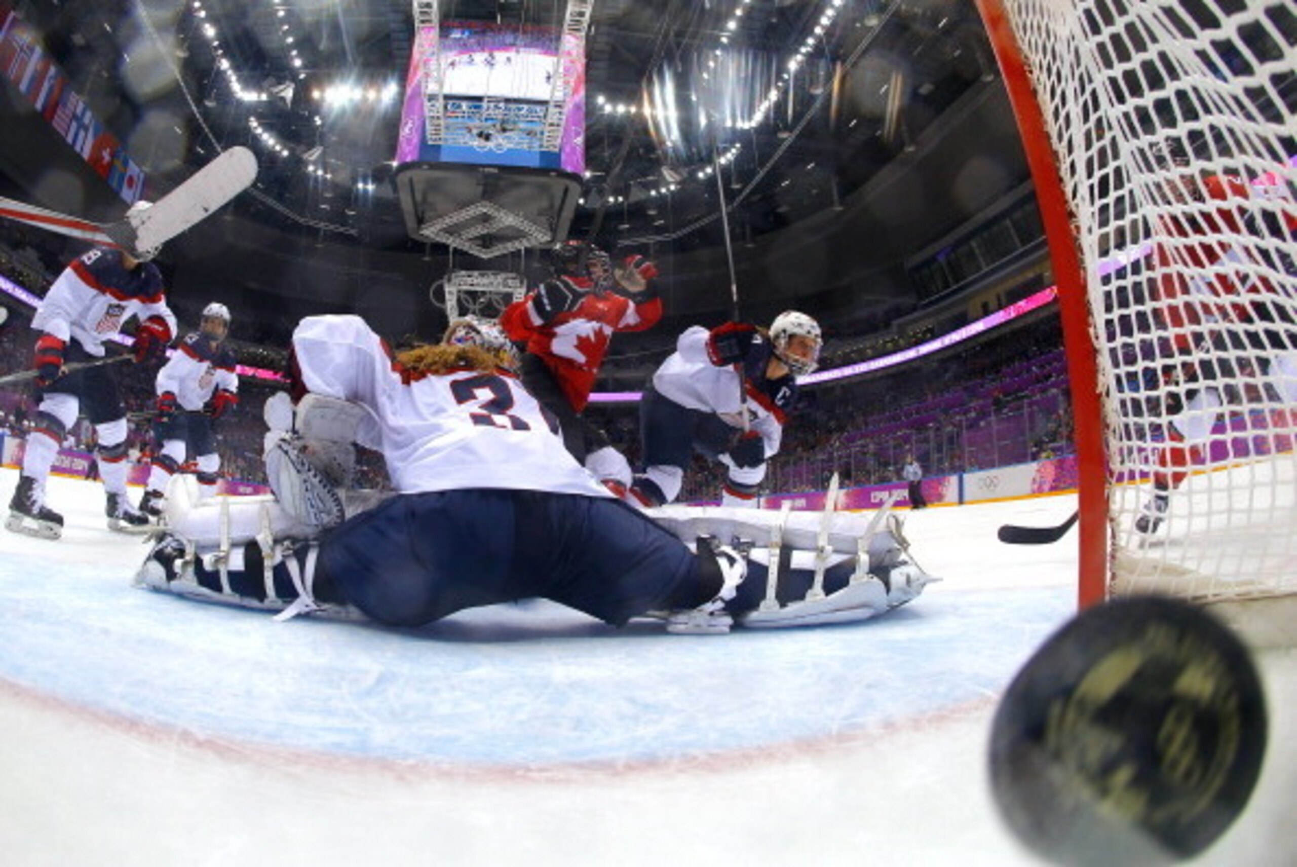 SOCHI, RUSSIA - FEBRUARY 20:  Marie-Philip Poulin #29 of Canada shoots and scores a third-period goal against Jessie Vetter #31 of the United States during the Ice Hockey Women's Gold Medal Game on day 13 of the Sochi 2014 Winter Olympics at Bolshoy Ice D