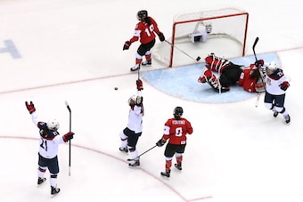 SOCHI, RUSSIA - FEBRUARY 20:  Alex Carpenter #25, Hilary Knight #21 and Kelli Stack #16 of the United States celebrate after Carpenter scored a third-period goal against Shannon Szabados #1 of Canada during the Ice Hockey Women's Gold Medal Game on day 13