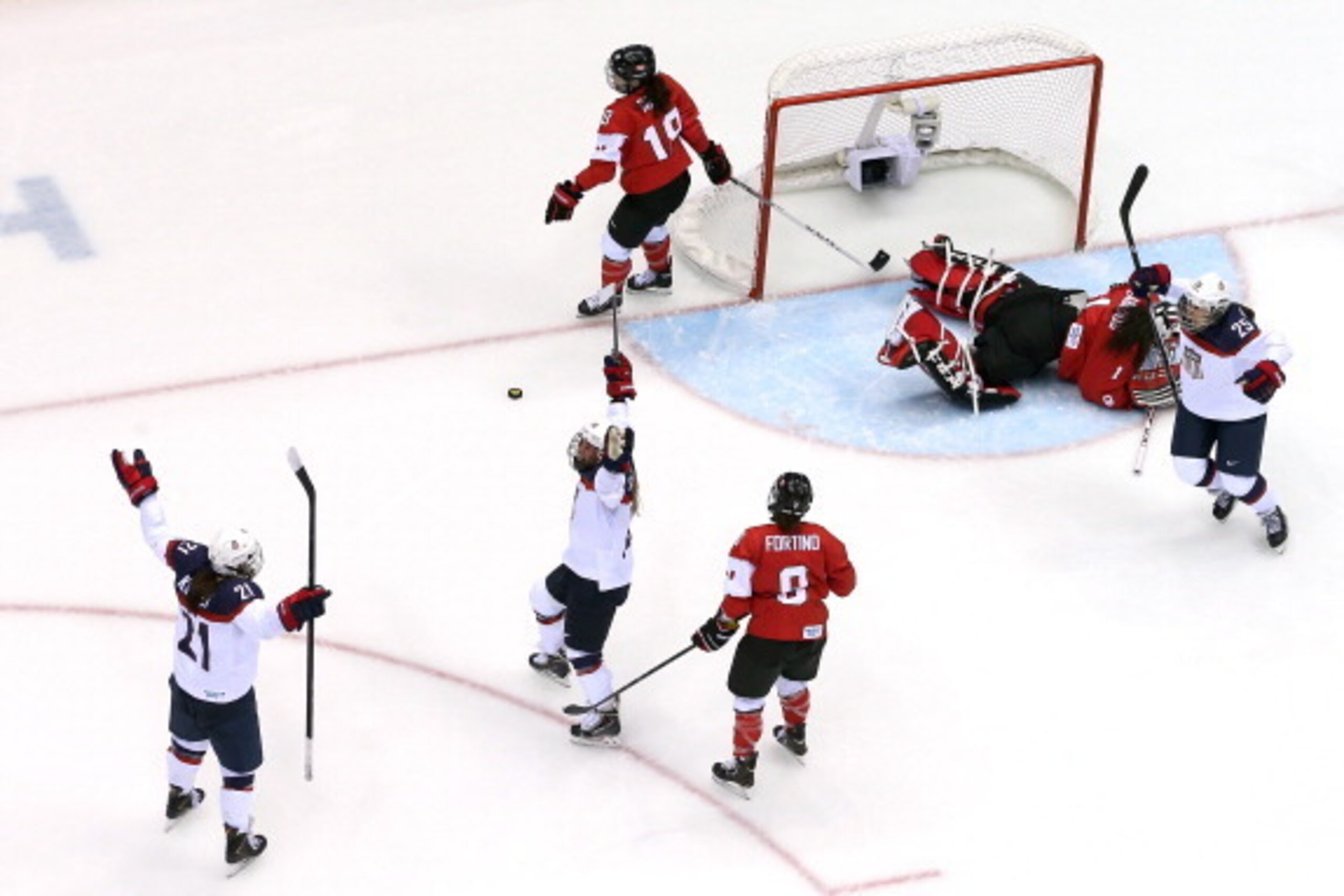 SOCHI, RUSSIA - FEBRUARY 20:  Alex Carpenter #25, Hilary Knight #21 and Kelli Stack #16 of the United States celebrate after Carpenter scored a third-period goal against Shannon Szabados #1 of Canada during the Ice Hockey Women's Gold Medal Game on day 13