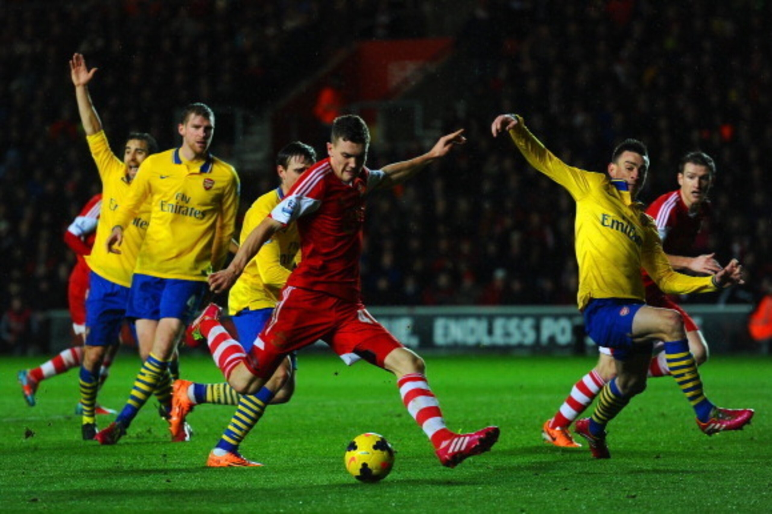 SOUTHAMPTON, ENGLAND - JANUARY 28:  Sam Gallagher of Southampton takes a shot at goal that is blocked by Laurent Koscielny of Arsenal during the Barclays Premier League match between Southampton and Arsenal at St Mary's Stadium on January 28, 2014 in Sout