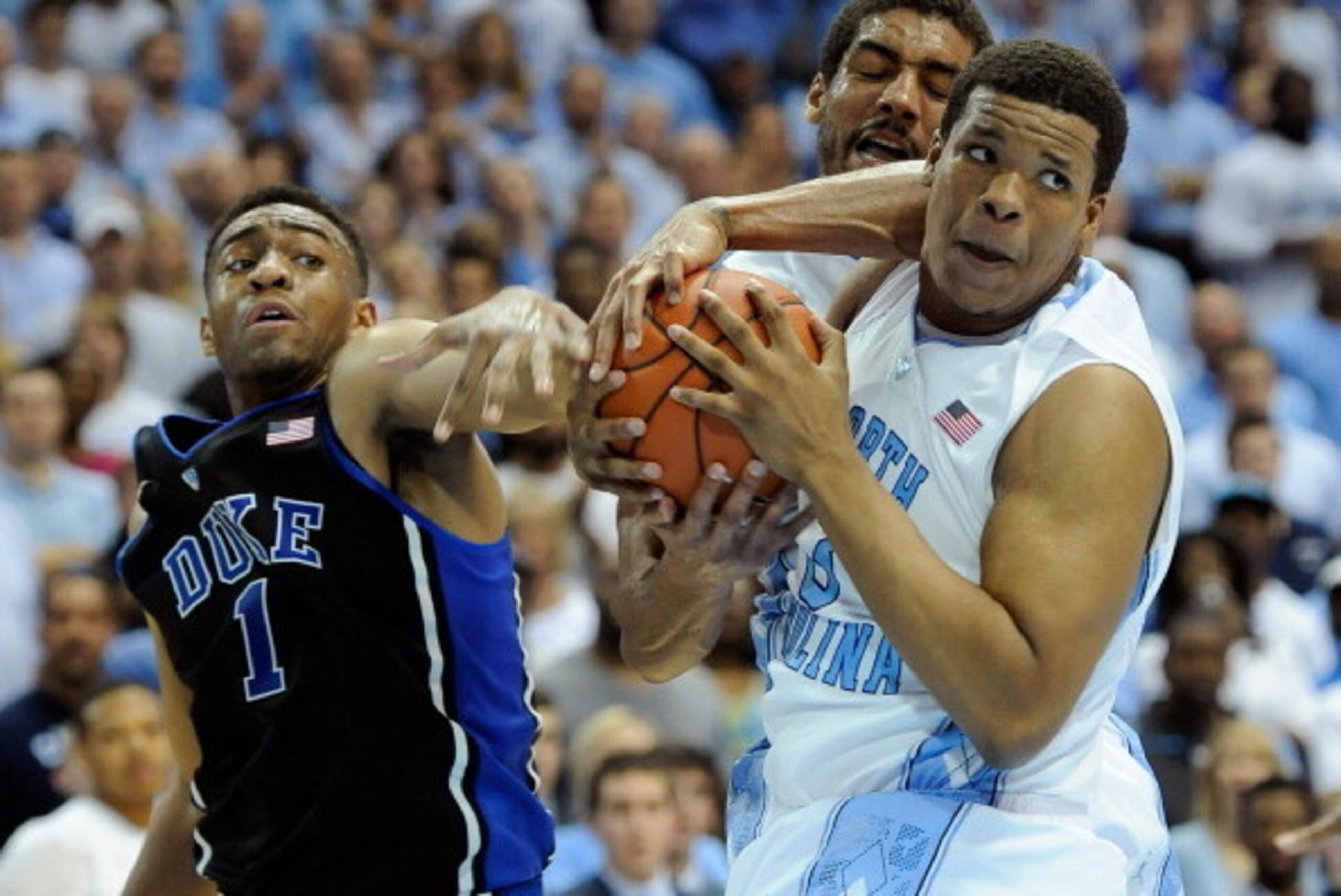 CHAPEL HILL, NC - FEBRUARY 20:  Jabari Parker #1 of the Duke Blue Devils battles James Michael McAdoo #43 and Kennedy Meeks #3 of the North Carolina Tar Heels for a rebound during their game at the Dean Smith Center on February 20, 2014 in Chapel Hill, No