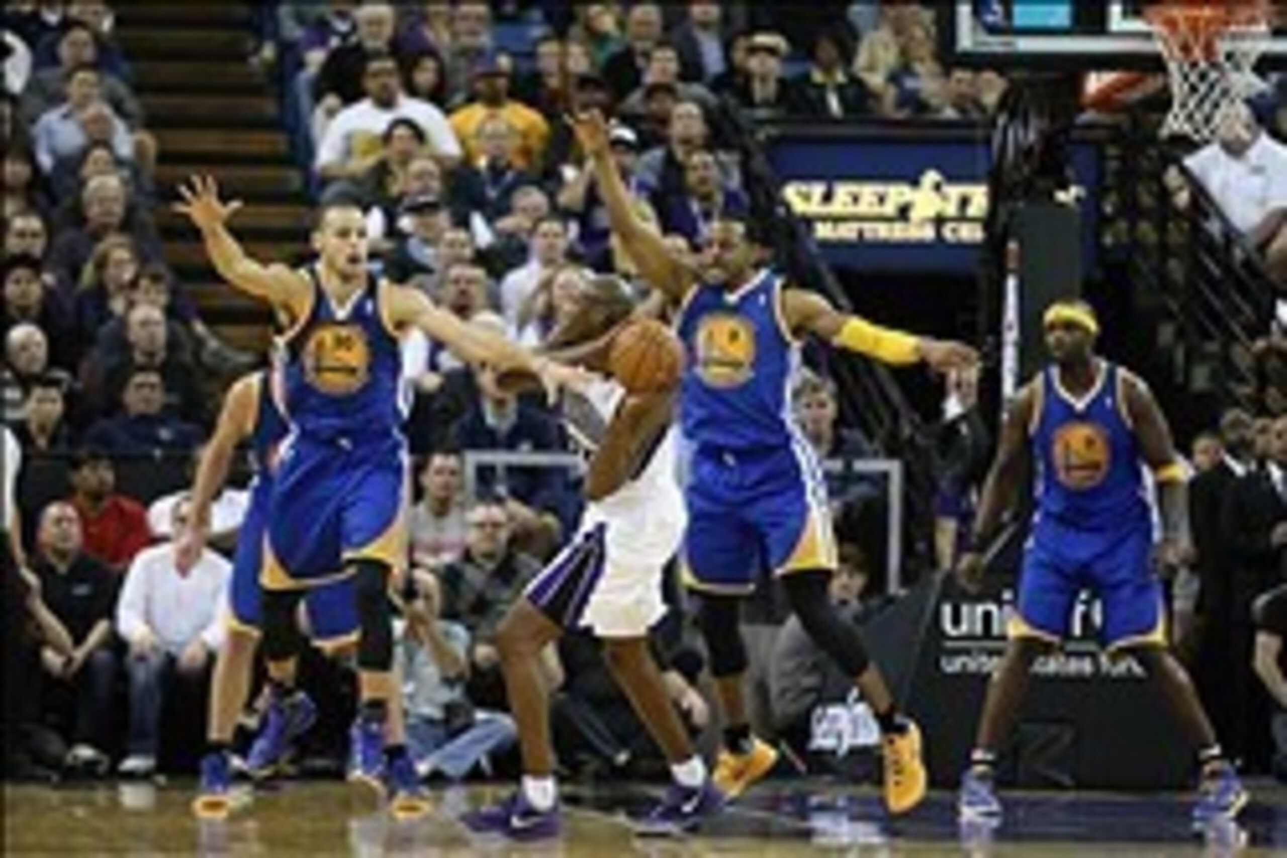 Feb 19, 2014; Sacramento, CA, USA; Sacramento Kings small forward Travis Outlaw (25) controls the ball against Golden State Warriors point guard Stephen Curry (30) and small forward Andre Iguodala (9) during the second quarter at Sleep Train Arena. Mandat