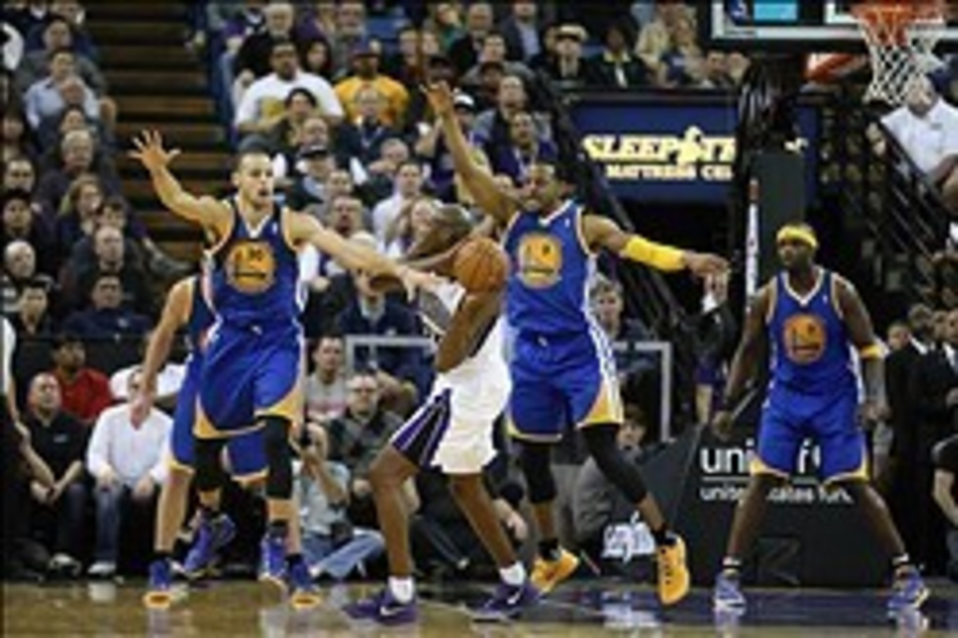 Feb 19, 2014; Sacramento, CA, USA; Sacramento Kings small forward Travis Outlaw (25) controls the ball against Golden State Warriors point guard Stephen Curry (30) and small forward Andre Iguodala (9) during the second quarter at Sleep Train Arena. Mandat