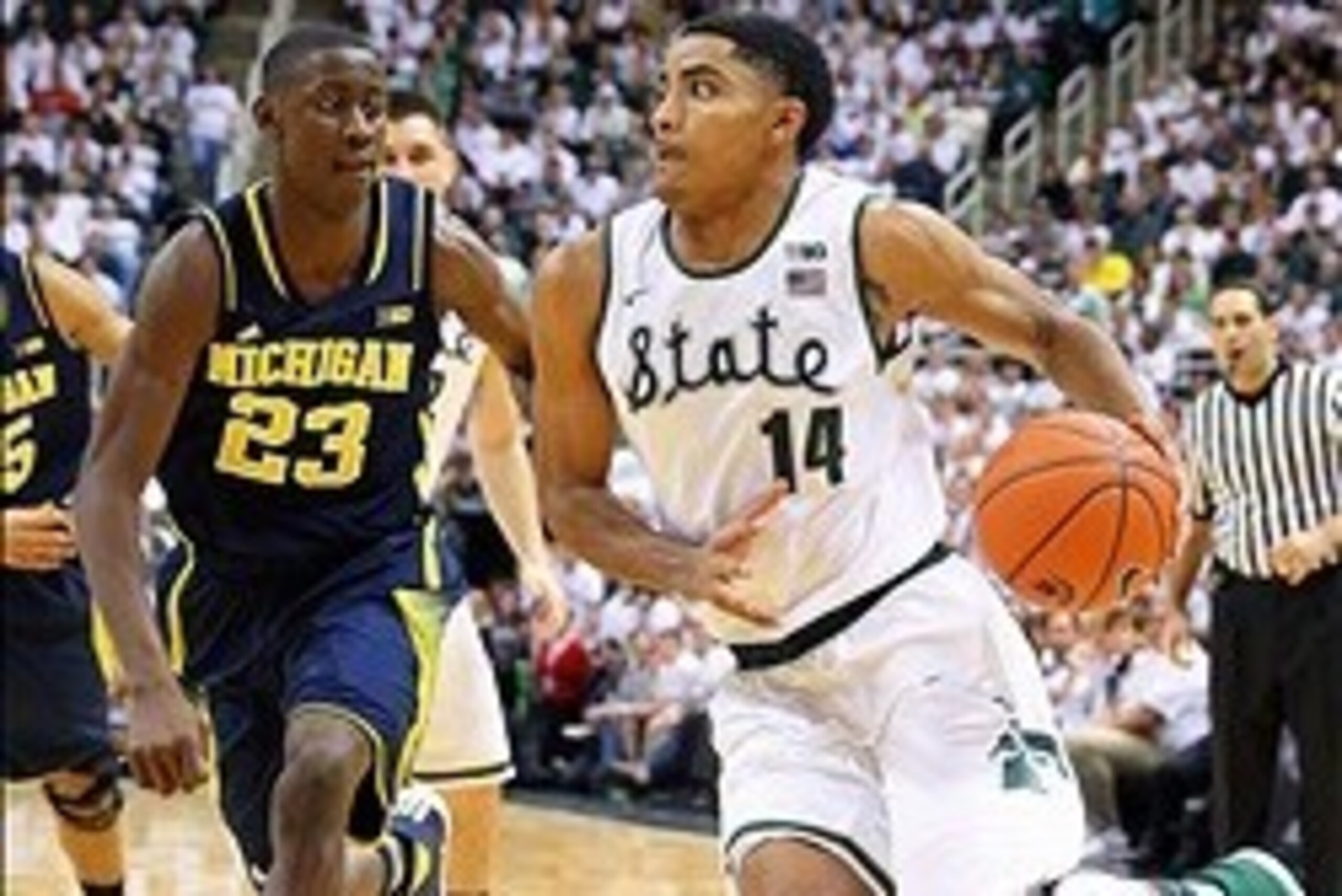 Jan 25, 2014; East Lansing, MI, USA;Michigan State Spartans guard Gary Harris (14) drives to the basket against Michigan Wolverines guard Caris LeVert (23)  during the 2nd half of a game at Jack Breslin Student Events Center. Michigan won 80-75. Mandatory
