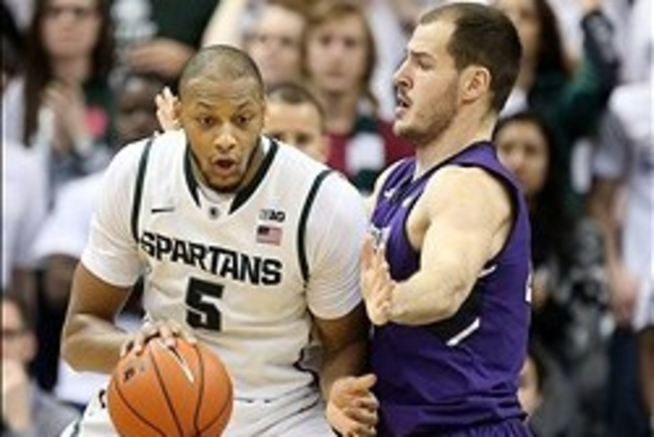 Feb 13, 2014; East Lansing, MI, USA; Michigan State Spartans forward Adreian Payne (5) posts up against Northwestern Wildcats guard/forward Sanjay Lumpkin (34) during the 1st half of a game at Jack Breslin Student Events Center. Mandatory Credit: Mike Car