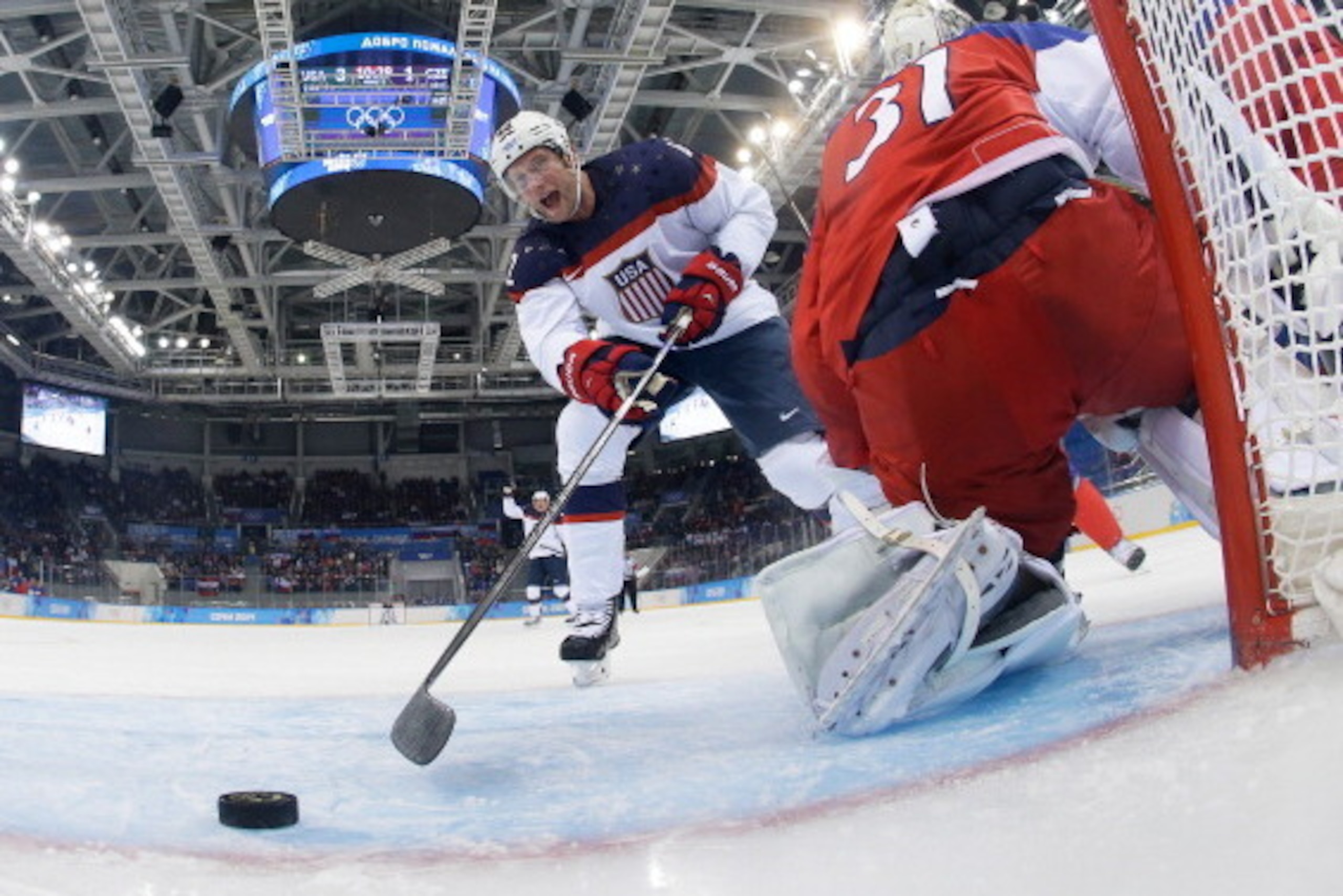 SOCHI, - - FEBRUARY 19:  David Backes #42 of the United States scores his team's third goal in the first period against Ondrej Pavelec #31 of the Czech Republic during the Men's Ice Hockey Quarterfinal Playoff on Day 12 of the 2014 Sochi Winter Olympics a