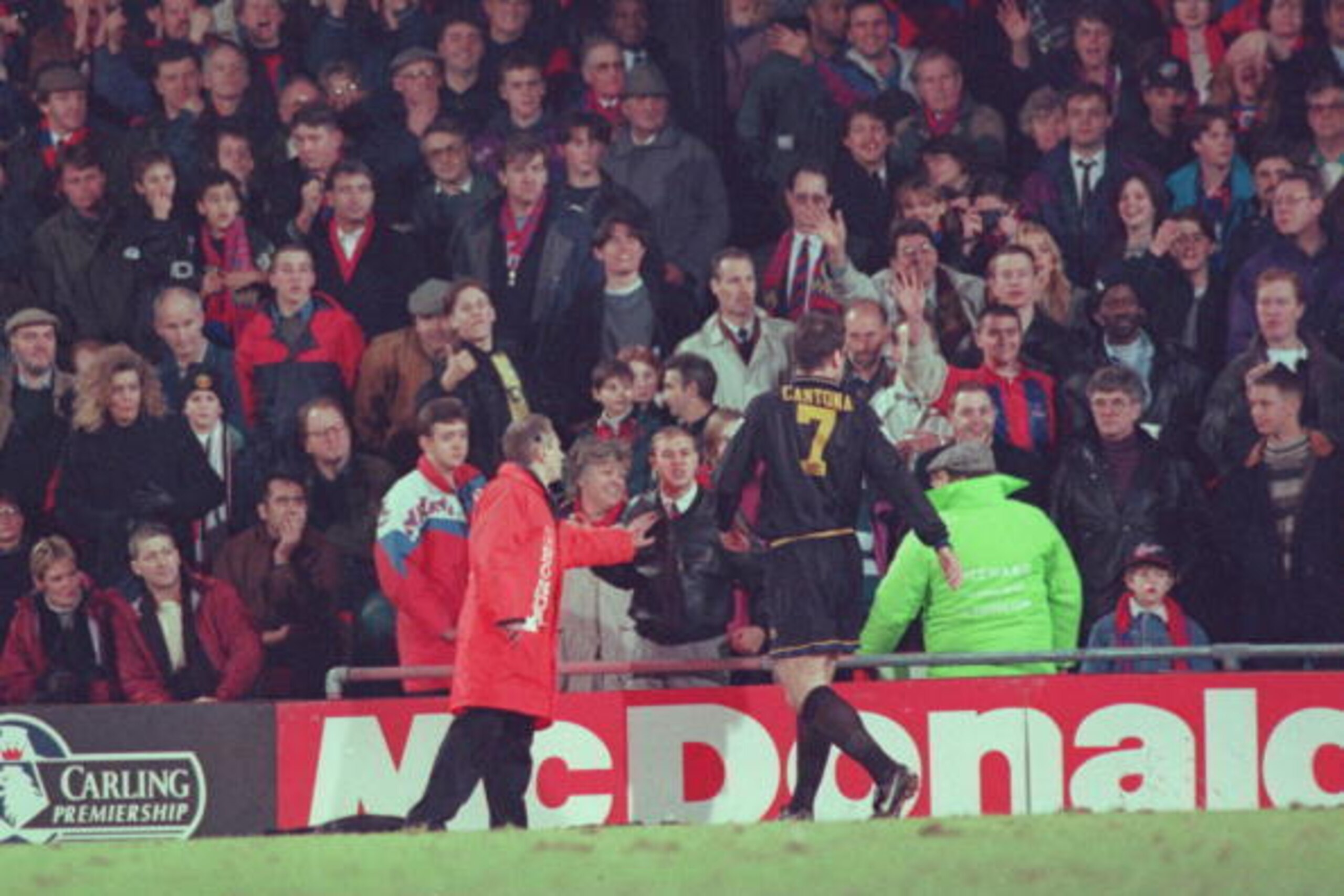 25 JAN 1995:  ERIC CANTONA OF MANCHESTER UNITED IS INVOLVED IN A FIGHT WITH A FAN AFTER HE WAS SENT OFF DURING THE CRYSTAL PALACE V MANCHESTER UNITED MATCH AT SELHURST PARK. Mandatory Credit: Shaun Botterill/ALLSPORT