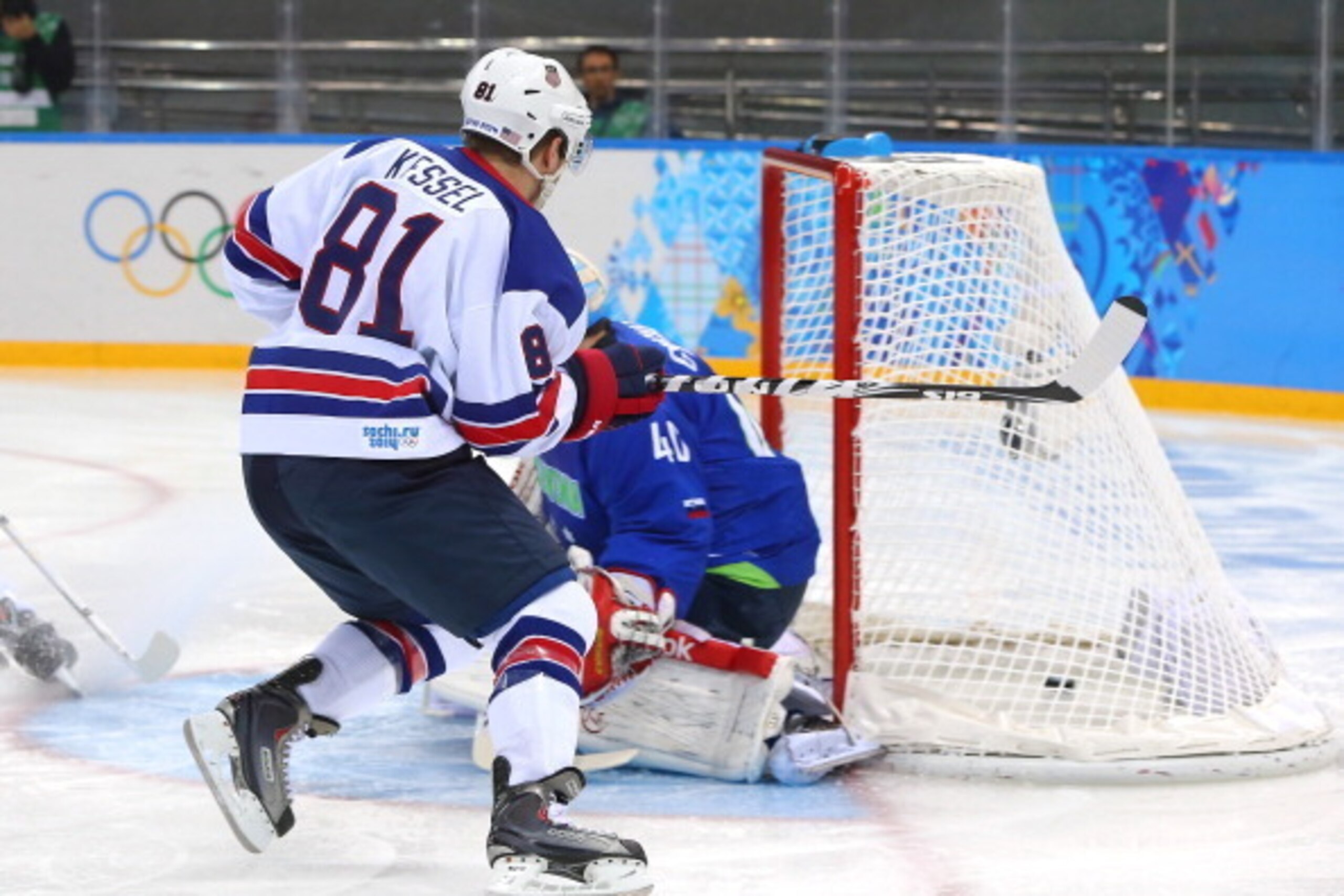SOCHI, RUSSIA - FEBRUARY 16: Phil Kessel #81 of the United States scores against Luka Gracnar #40 of Slovenia in the first period during the Men's Ice Hockey Preliminary Round Group A game on day nine of the Sochi 2014 Winter Olympics at Shayba Arena on F