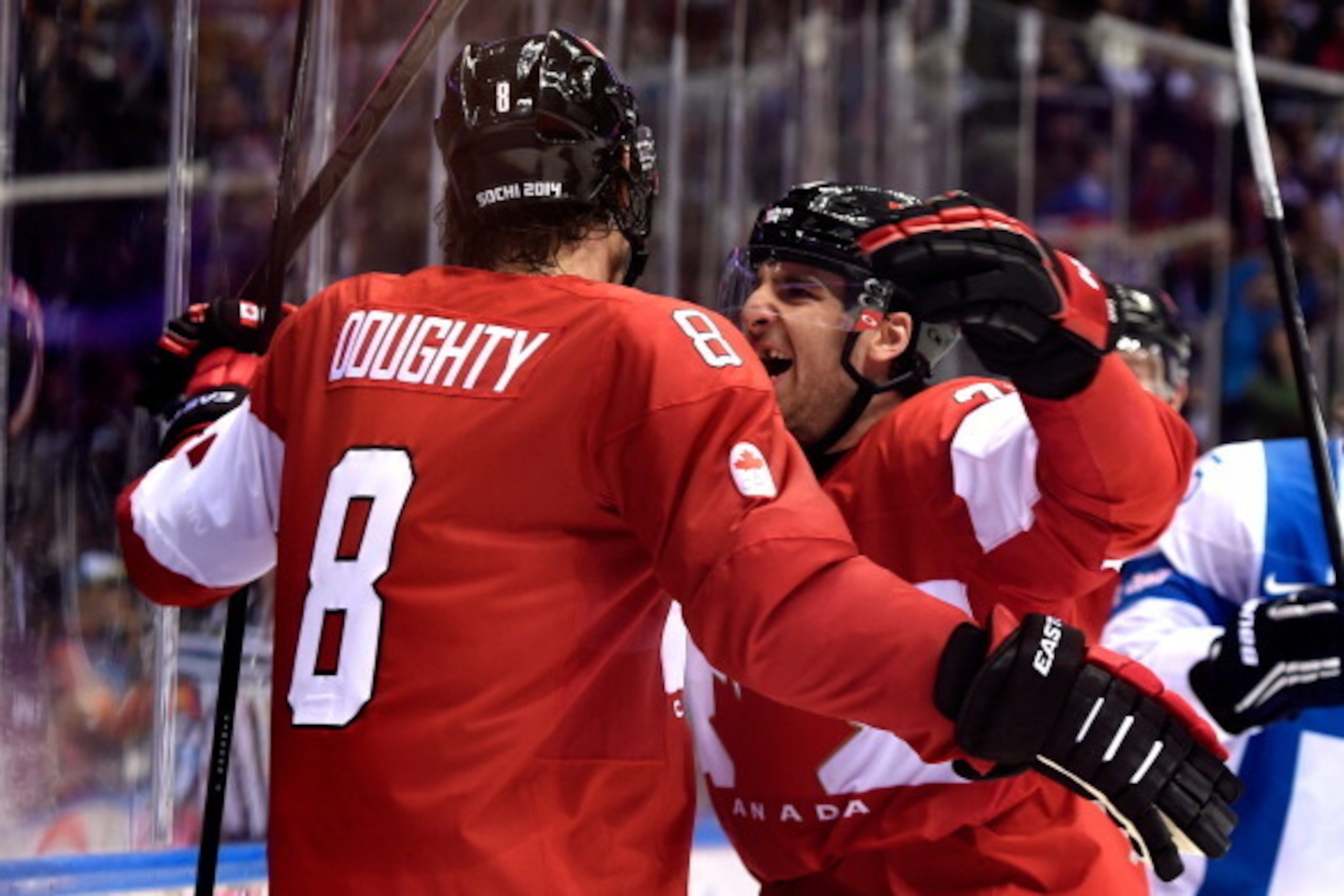 SOCHI, RUSSIA - FEBRUARY 16:  Drew Doughty #8 of Canada celebrates with his teammate John Tavares #20 after scoring the game winning goal in overtime against Tuukka Rask #40 of Finland during the Men's Ice Hockey Preliminary Round Group B game on day nine
