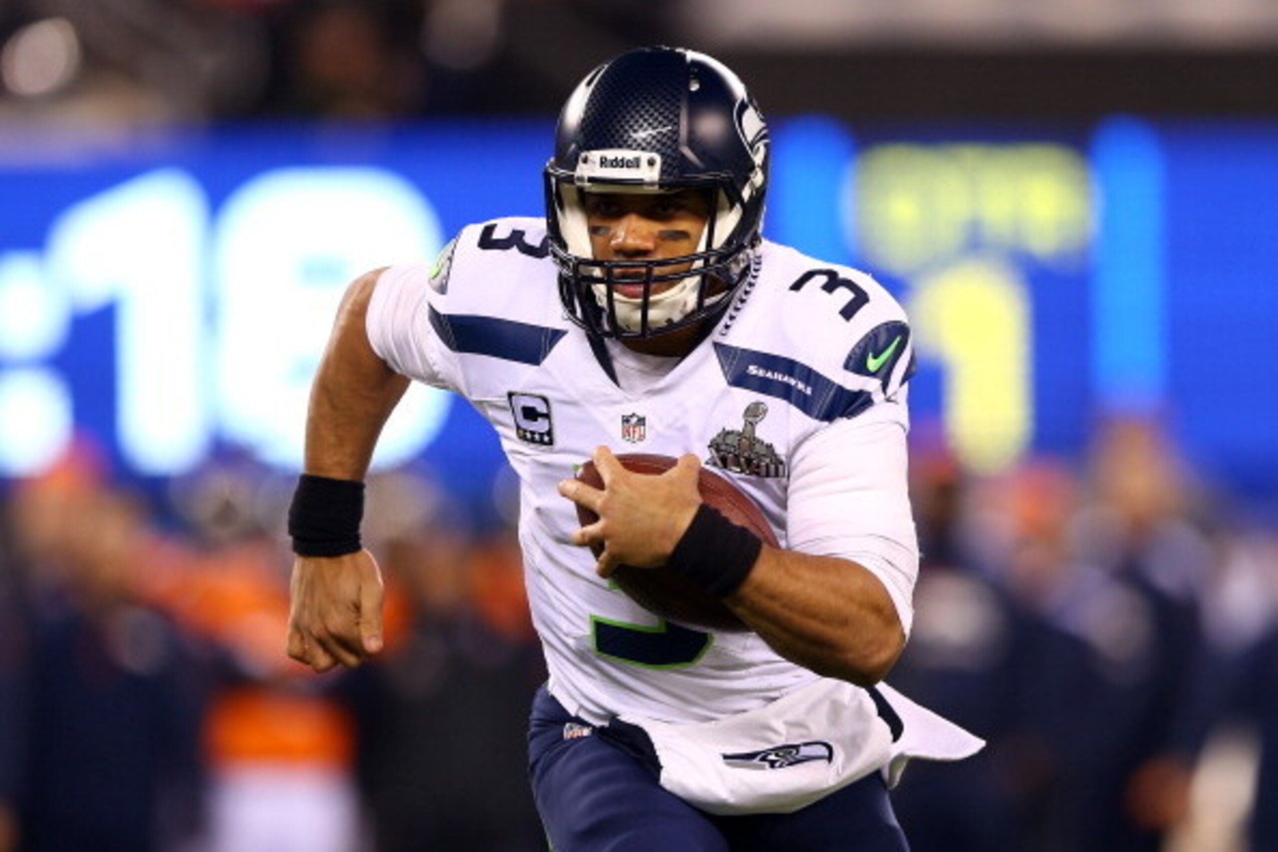 EAST RUTHERFORD, NJ - FEBRUARY 02: Quarterback Russell Wilson #3 of the Seattle Seahawks runs the ball against the Denver Broncos during Super Bowl XLVIII at MetLife Stadium on February 2, 2014 in East Rutherford, New Jersey. (Photo by Elsa/Getty Images EAST RUTHERFORD, NJ - FEBRUARY 02: Quarterback Russell Wilson #3 of the Seattle Seahawks runs the ball against the Denver Broncos during Super Bowl XLVIII at MetLife Stadium on February 2, 2014 in East Rutherford, New Jersey. (Photo by Elsa/Getty Images