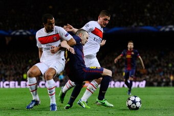 BARCELONA, SPAIN - APRIL 10:  Lucas and Marco Verratti of PSG close down Andres Iniesta of Barcelona during the UEFA Champions League quarter-final second leg match between Barcelona and Paris St Germain at Nou Camp on April 10, 2013 in Barcelona, Spain. 